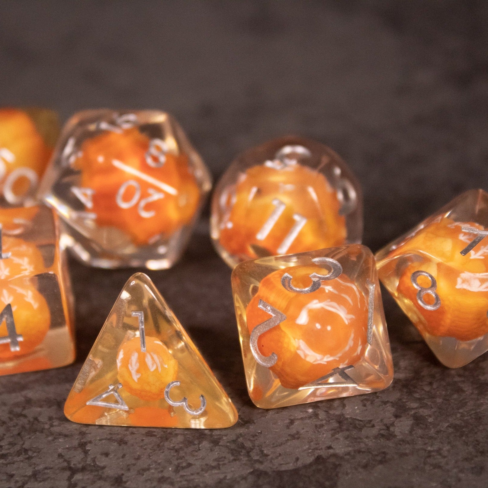 Orange Fruit Dice Set - Set of transparent polyhedral dice with orange fruit design and white numbering.