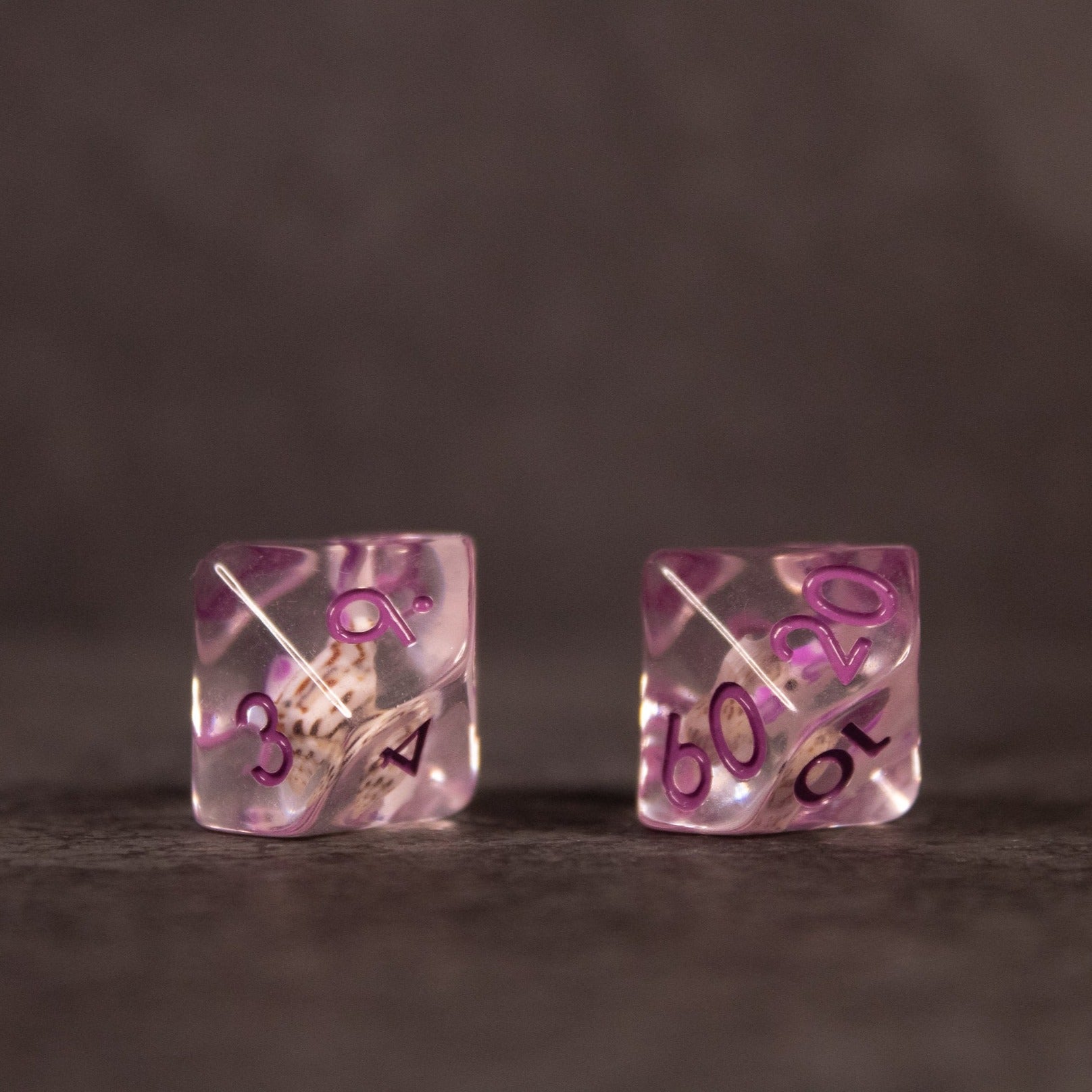 Purple Koi Fish and Seashell Dice Set - Transparent purple dice with embedded koi fish and seashell designs, black numbering.