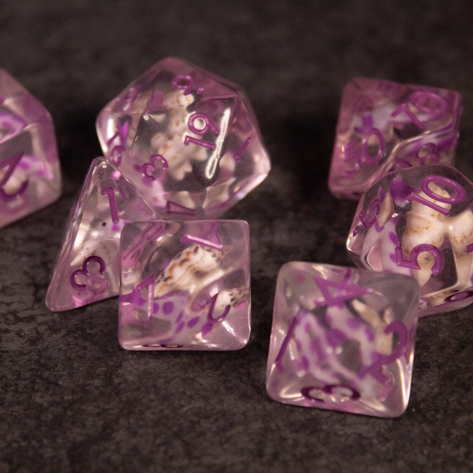 Purple Koi Fish and Seashell Dice Set - Set of translucent purple polyhedral dice with embedded koi fish and seashell designs, featuring metallic numbering.