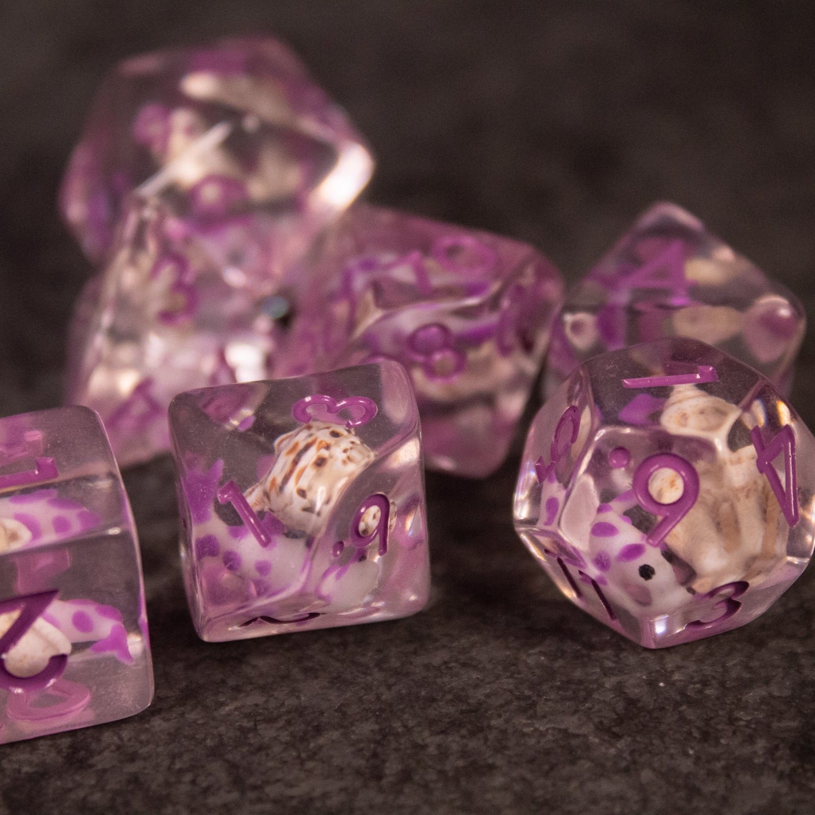 Purple Koi Fish and Seashell Dice Set - Translucent purple polyhedral dice set with white koi fish and delicate seashell inclusions.