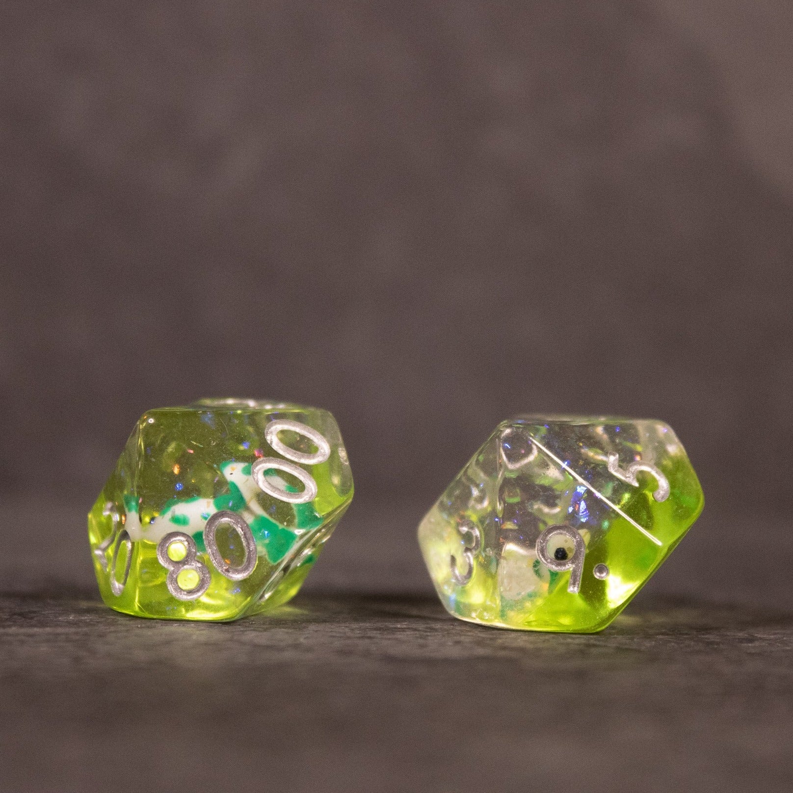 Green Koi Fish Dice Set - Two green translucent dice with embedded koi fish inclusions, showing white pips and numbers.