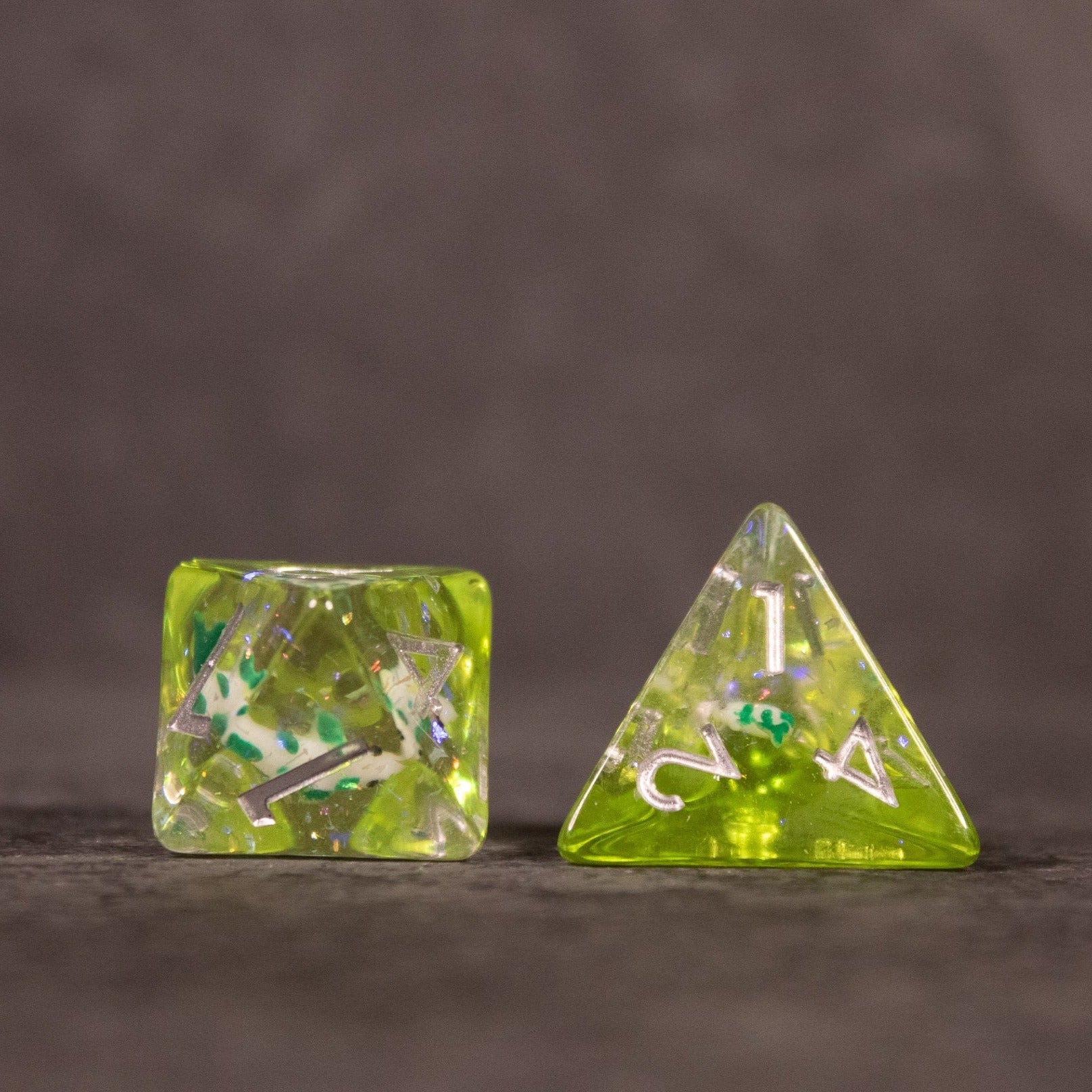 Green Koi Fish Dice Set - Green translucent dice set featuring embedded miniature koi fish, including a cube and a four-sided die with white numbering.