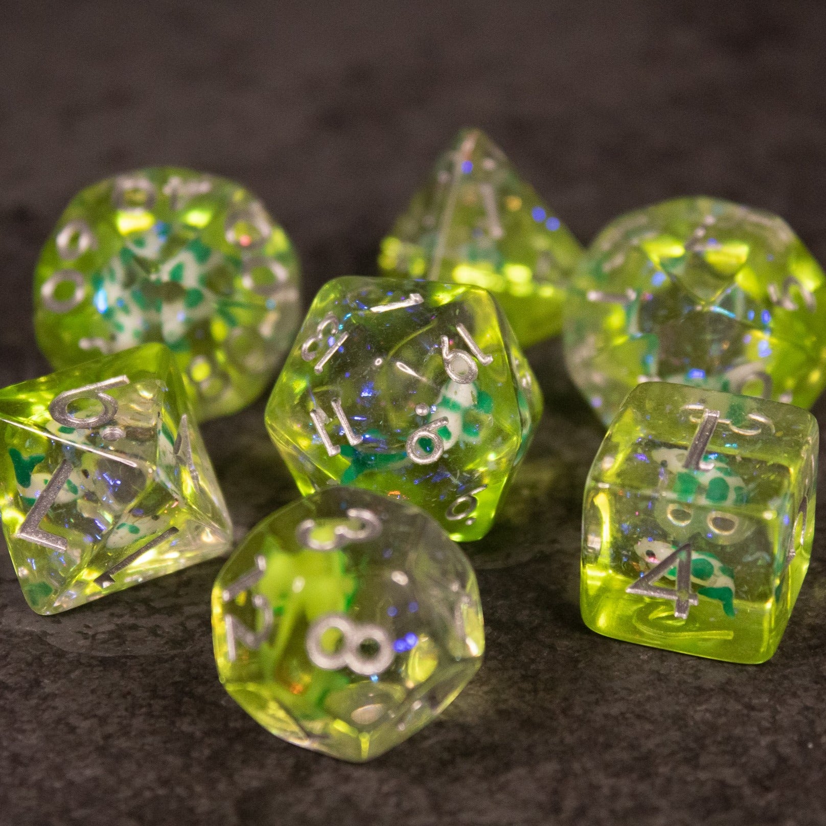 Green Koi Fish Dice Set - Green translucent polyhedral dice set with embedded koi fish and shimmering inclusions.