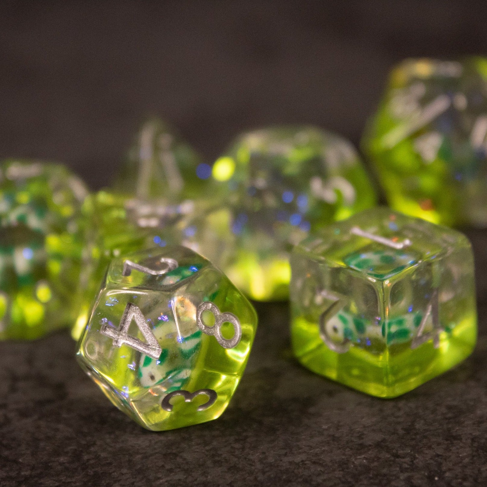 Green Koi Fish Dice Set - Set of translucent green dice with embedded koi fish and blue inclusions, featuring white numbering.