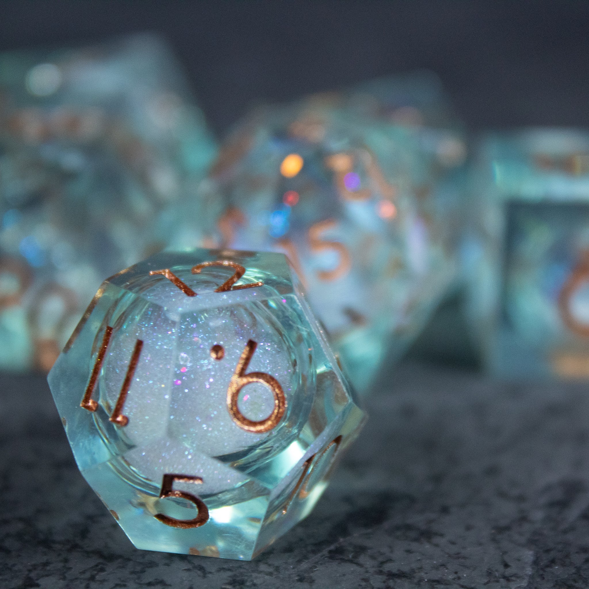 Will o' Wisp Liquid Core Dice Set - Translucent blue 20-sided dice with sharp edges and shimmering liquid core inside.