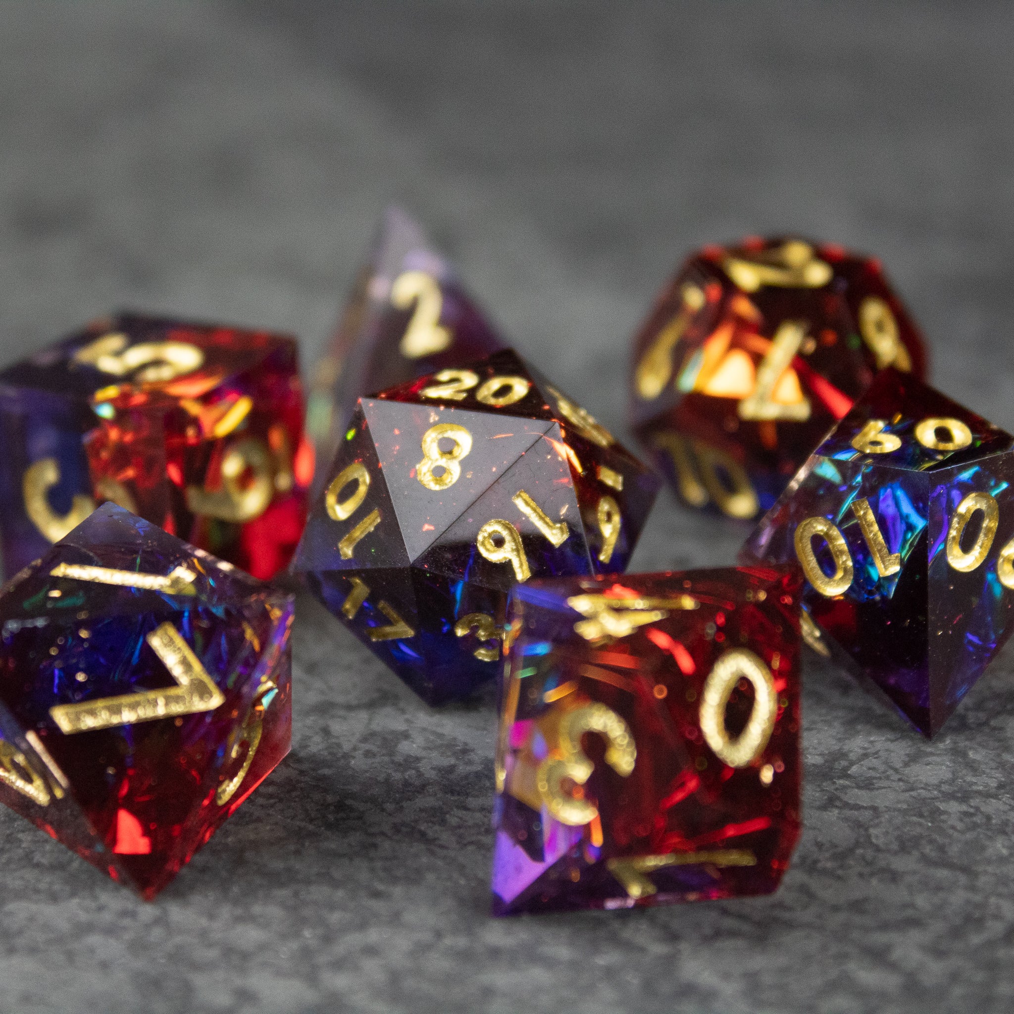 Electromancer Dice Set - Blue and red sharp-edged polyhedral dice set with gold numbering, including a d20 and d12.