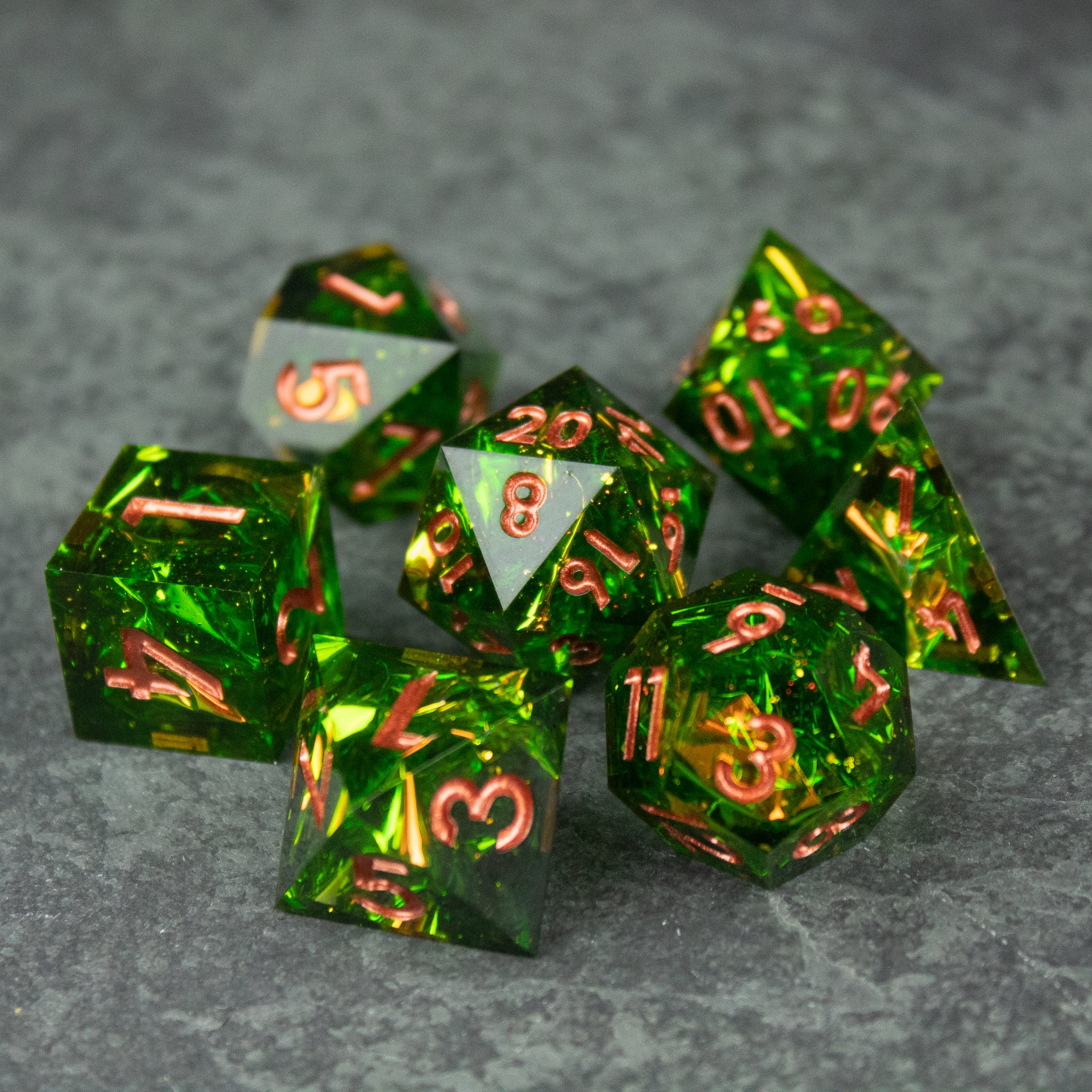 Venom Dice Set - Set of translucent green polyhedral dice with sharp edges and copper-colored numbers.