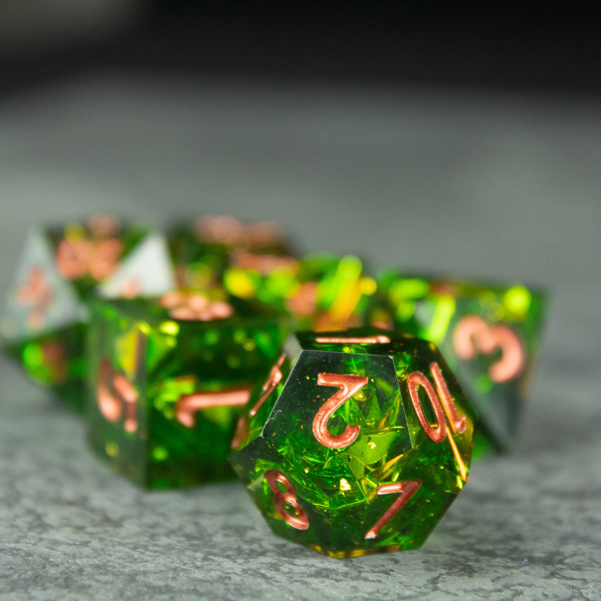 Venom Dice Set - Green translucent 20-sided dice with sharp edges and glowing orange numbers for tabletop games.