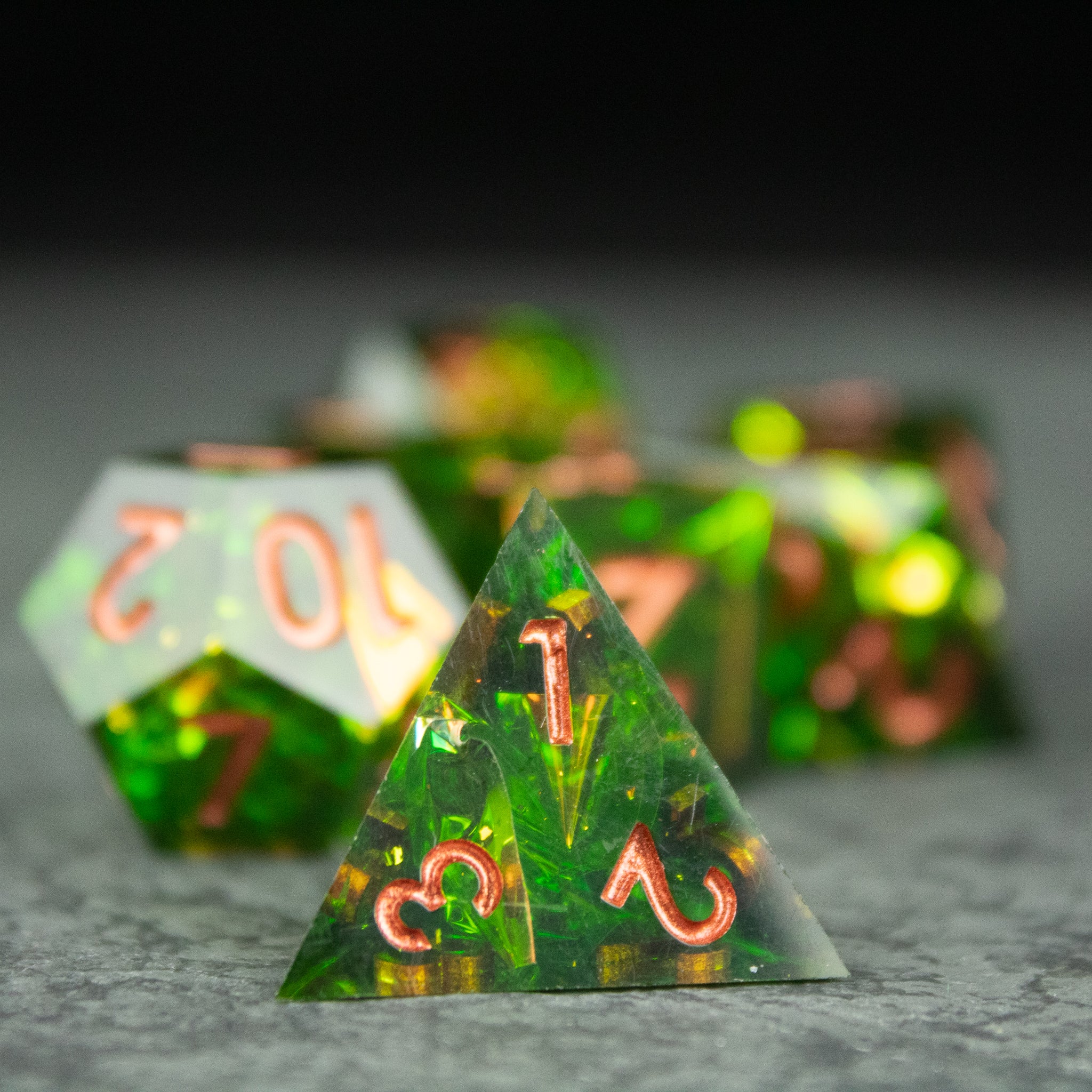 Venom Dice Set - Set of translucent green sharp-edged dice with copper-colored numbers, featuring intricate internal patterns.
