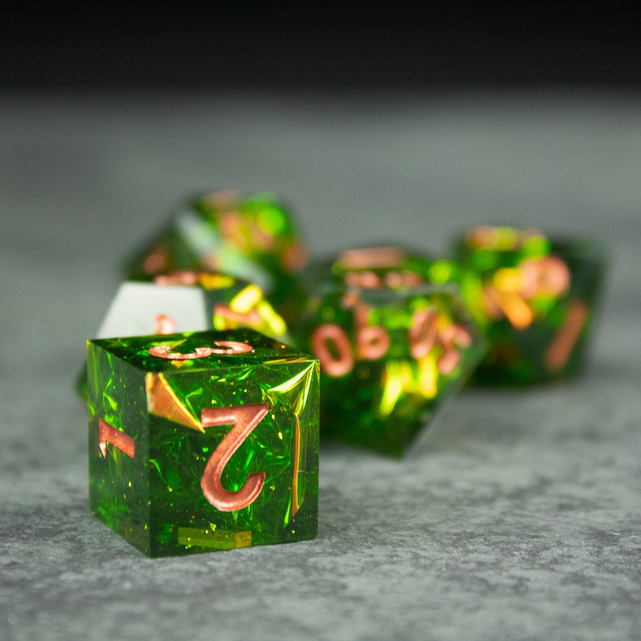 Venom Dice Set - Set of translucent green sharp-edged dice with gold numbering, glowing effect.