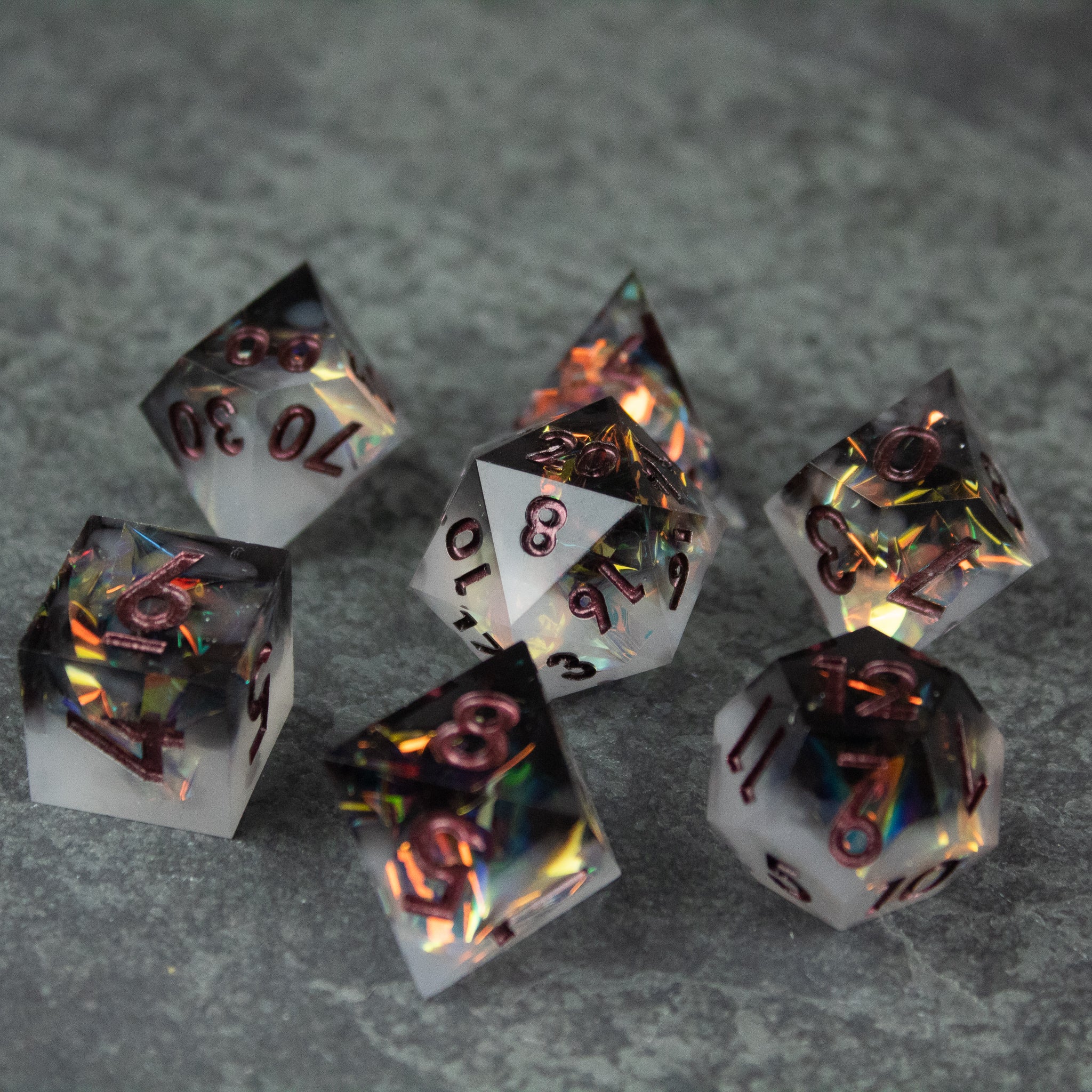 Oathbreaker Dice Set - Black and white sharp-edged dice set with red numbering on a gray textured surface.