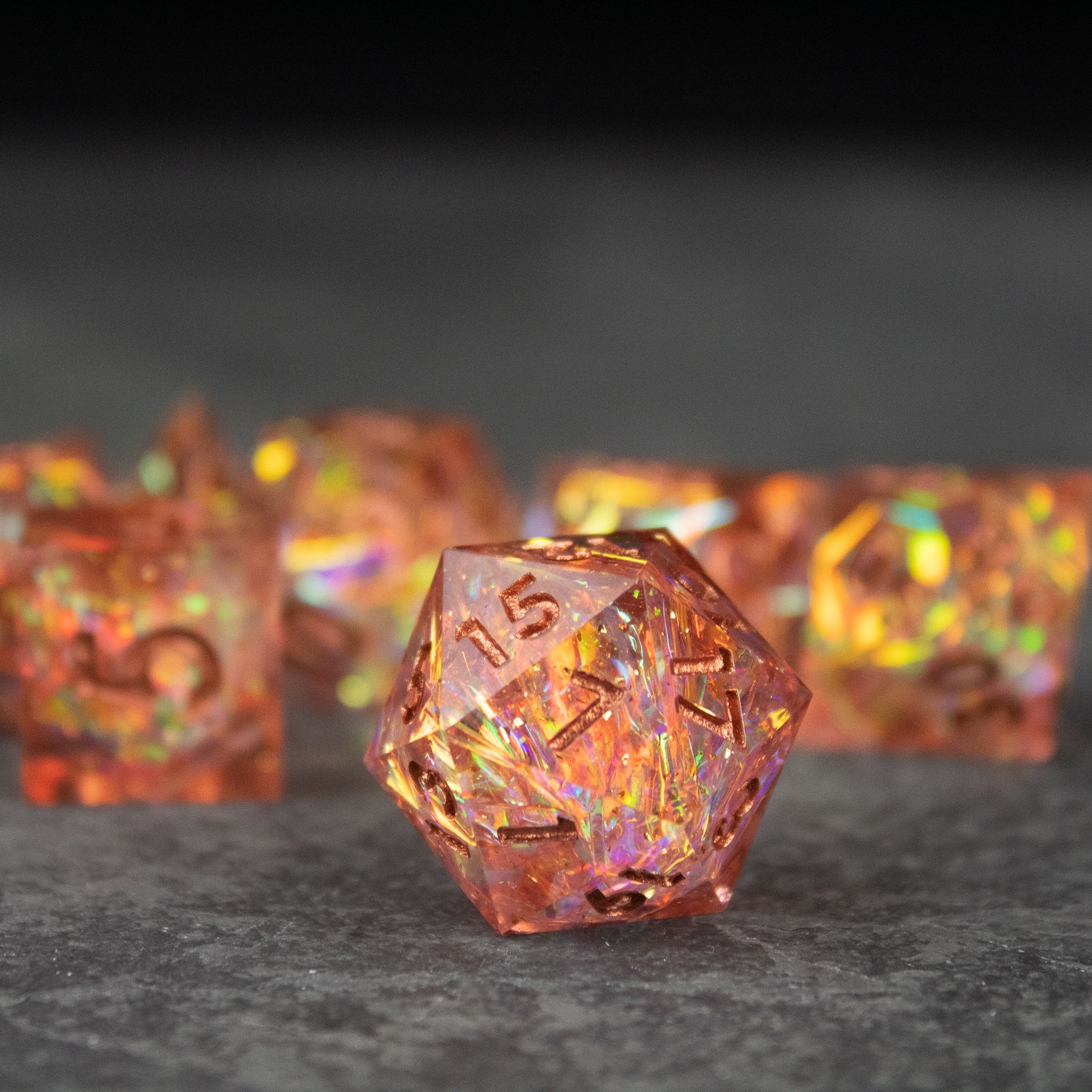 Sacred Flame Dice Set - Transparent orange polyhedral dice with holographic glitter and sharp edges, including a 20-sided die.