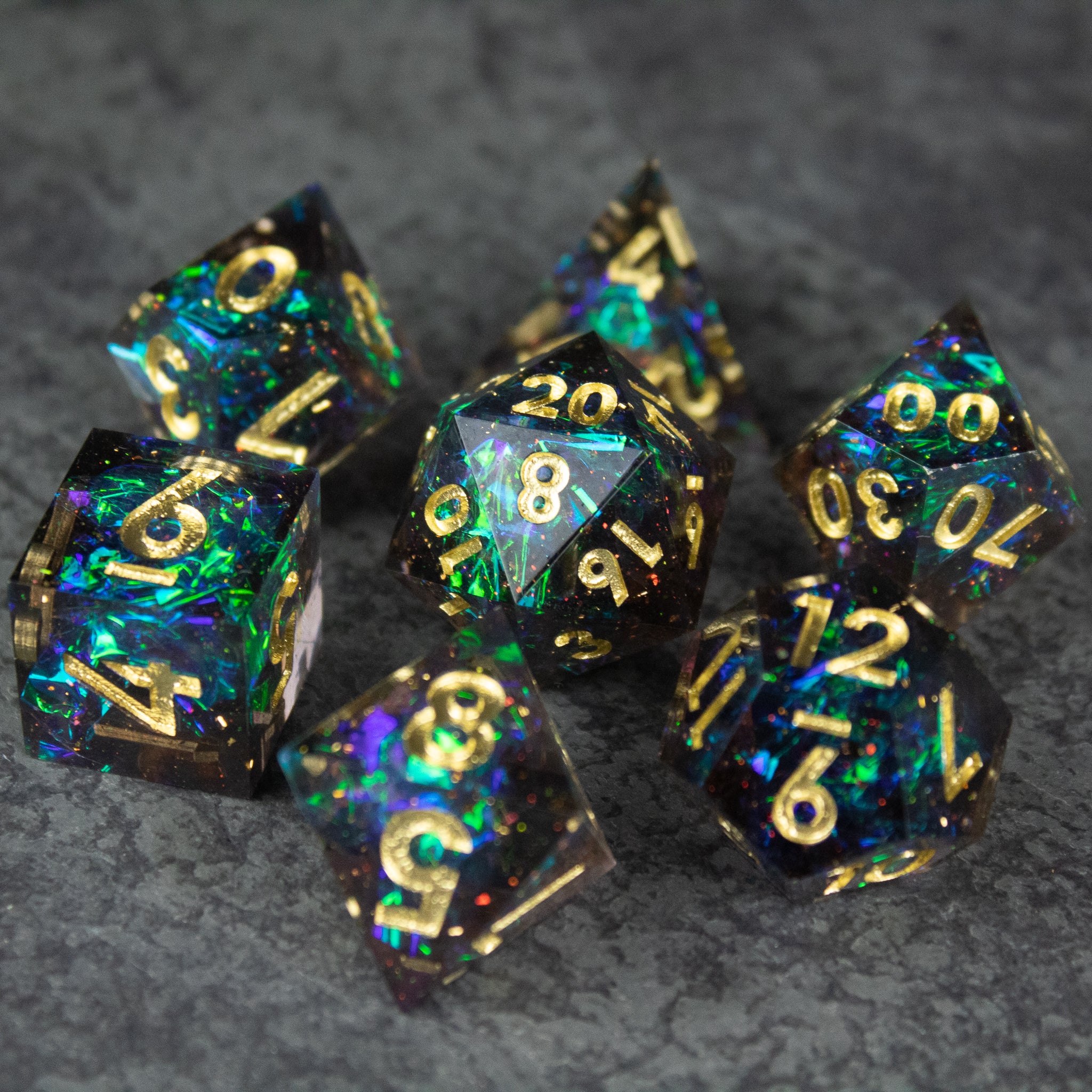Galaxy Dice Set - Black and blue galaxy-themed sharp edge dice set with gold numbers and glitter particles.