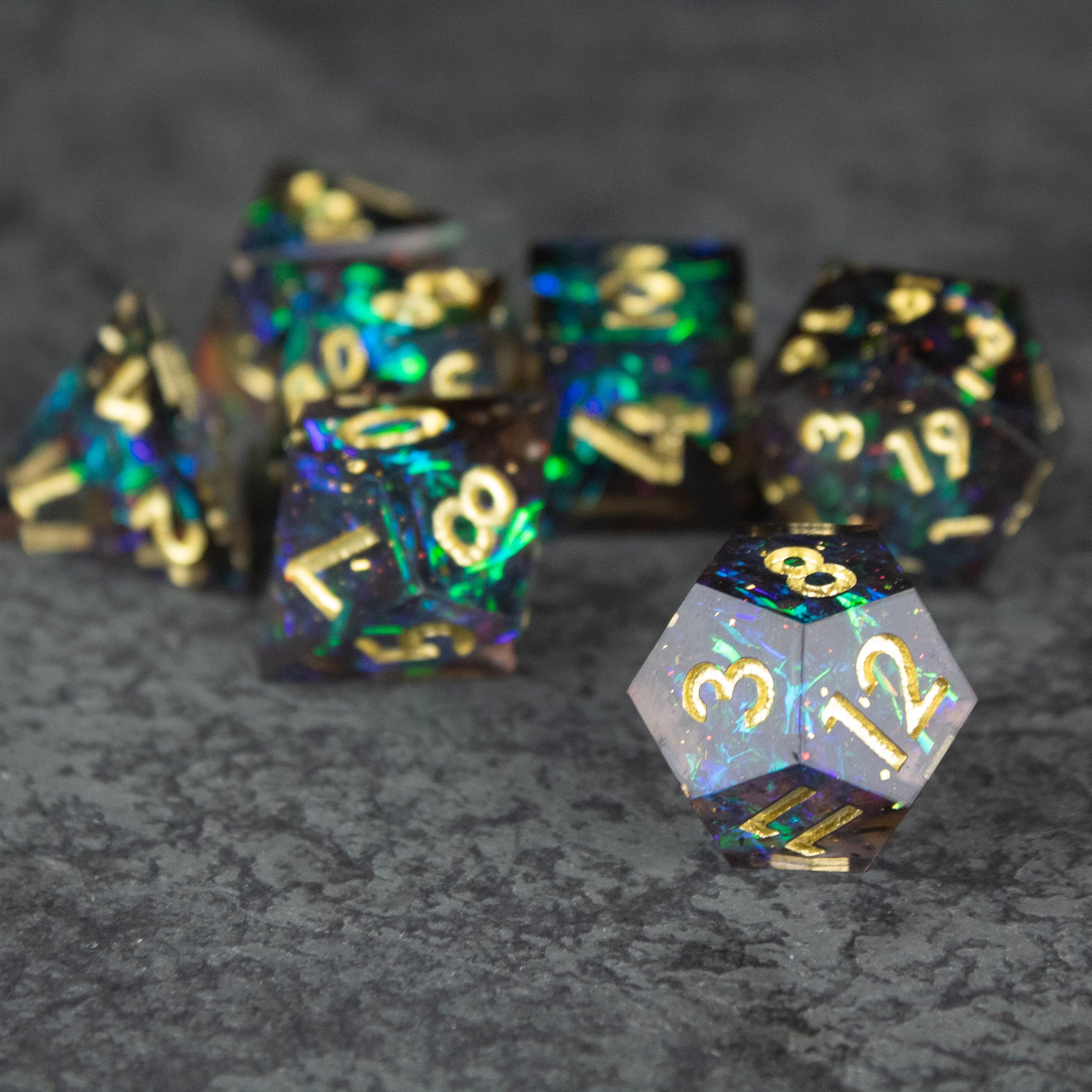 Galaxy Dice Set - Set of black and translucent polyhedral dice with gold numbers and sharp edges, featuring space-themed glitter.