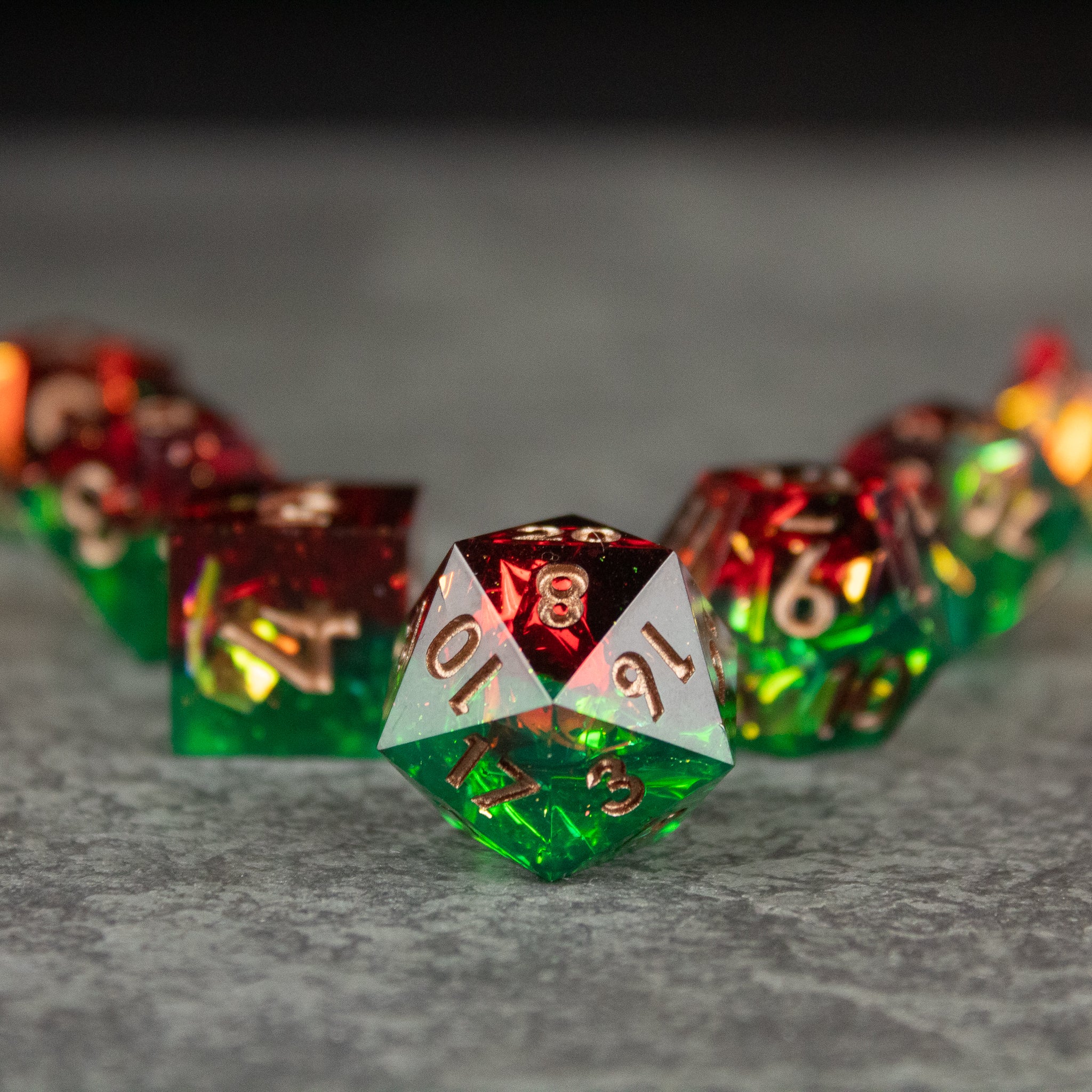 Jungle Fire Dice Set - Green and red sharp-edged polyhedral dice set with gold numbering, Jungle Fire Dice Set.