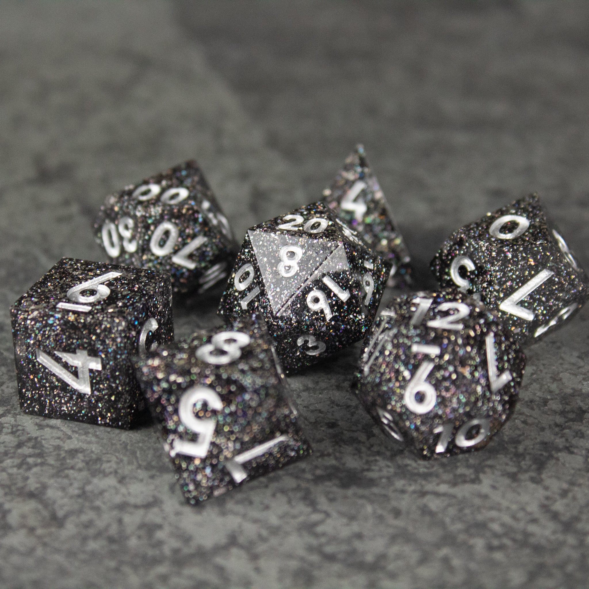 Starfield Dice Set - Glossy black polyhedral dice set with white numbering and silver glitter specks.