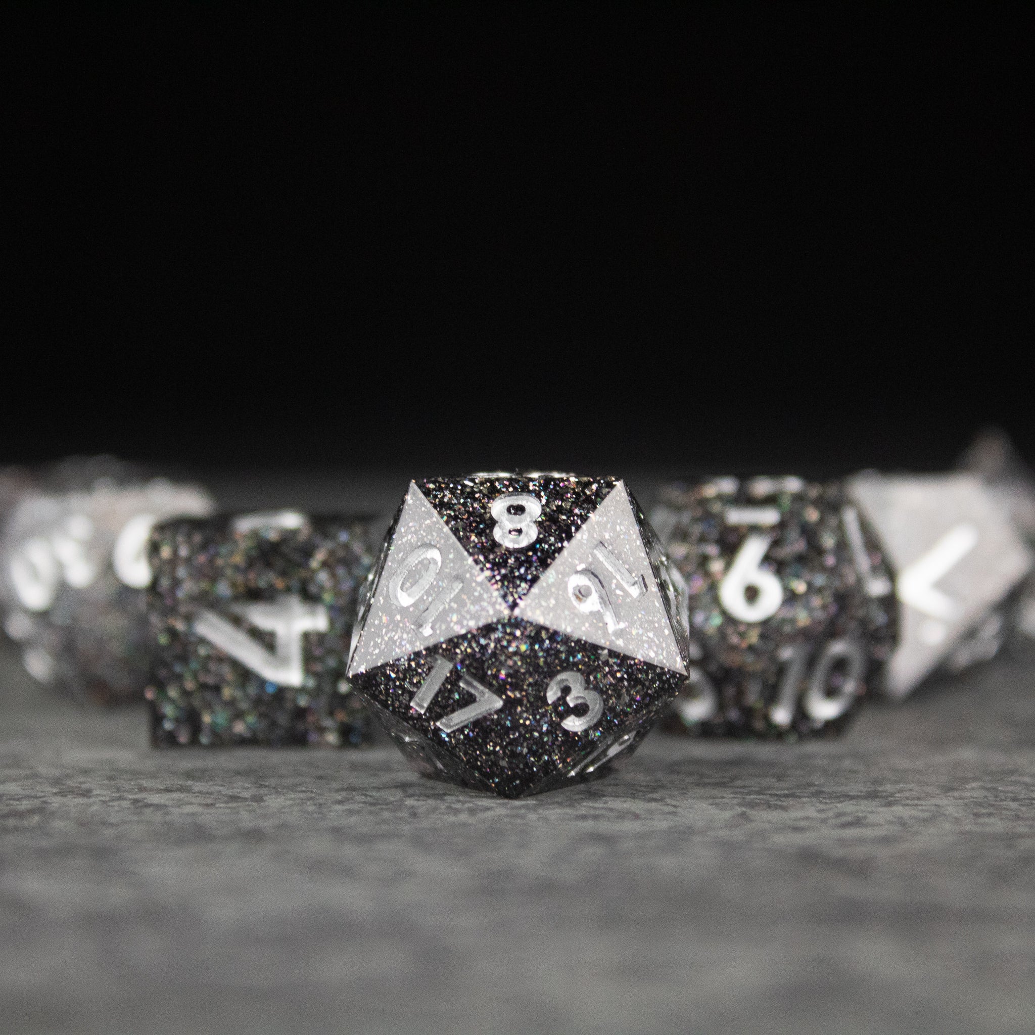 Starfield Dice Set - Black and white speckled sharp-edged polyhedral dice set with white numbering, including a 20-sided die, designed for.