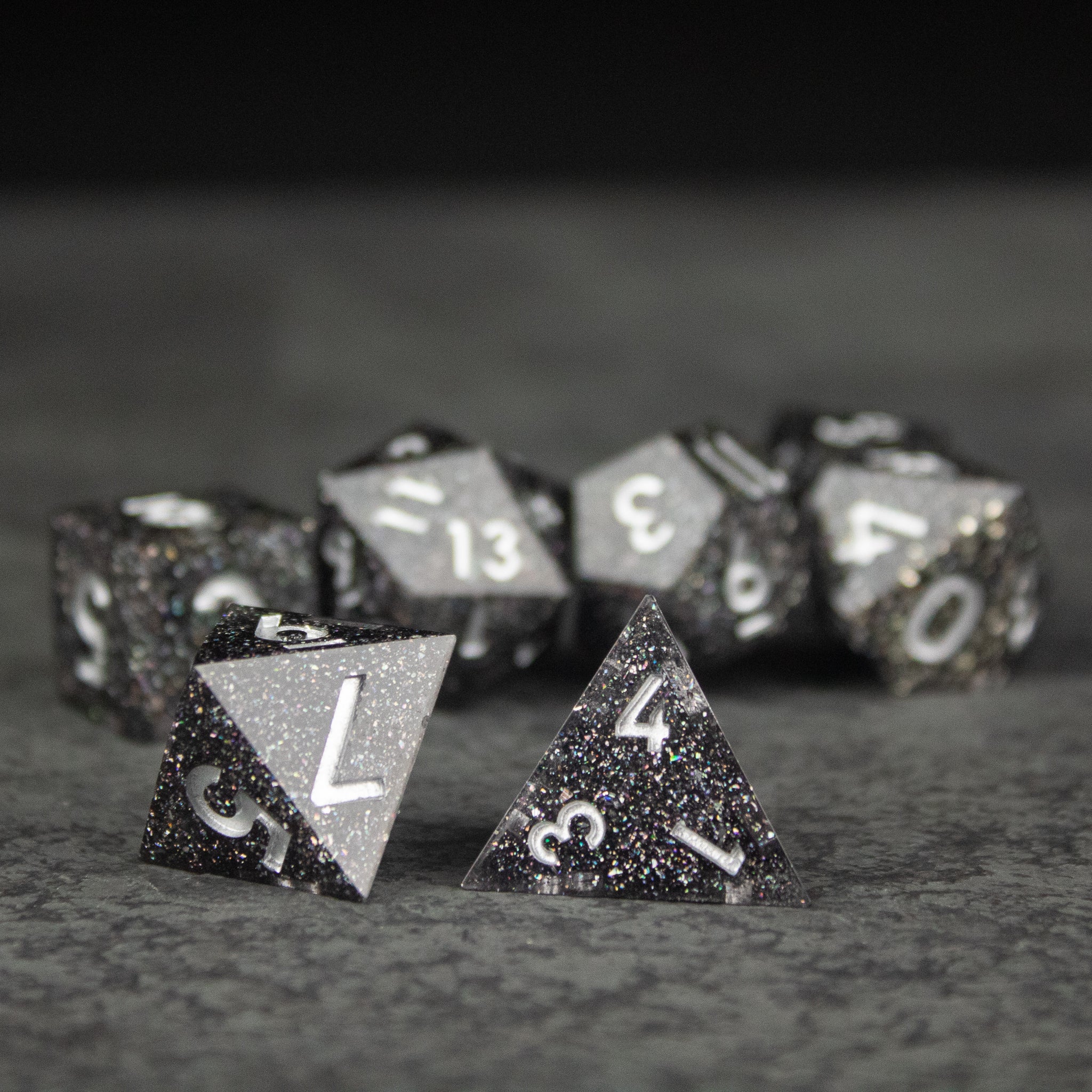 Starfield Dice Set - Black and silver glitter sharp-edged polyhedral dice set with white numbers for tabletop games.