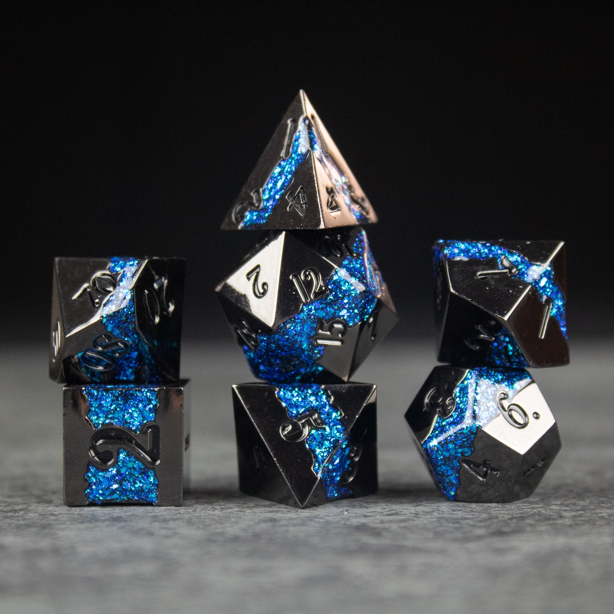 Blue Rift Dice Set - Black and blue metal polyhedral dice set with shimmering blue rift design.