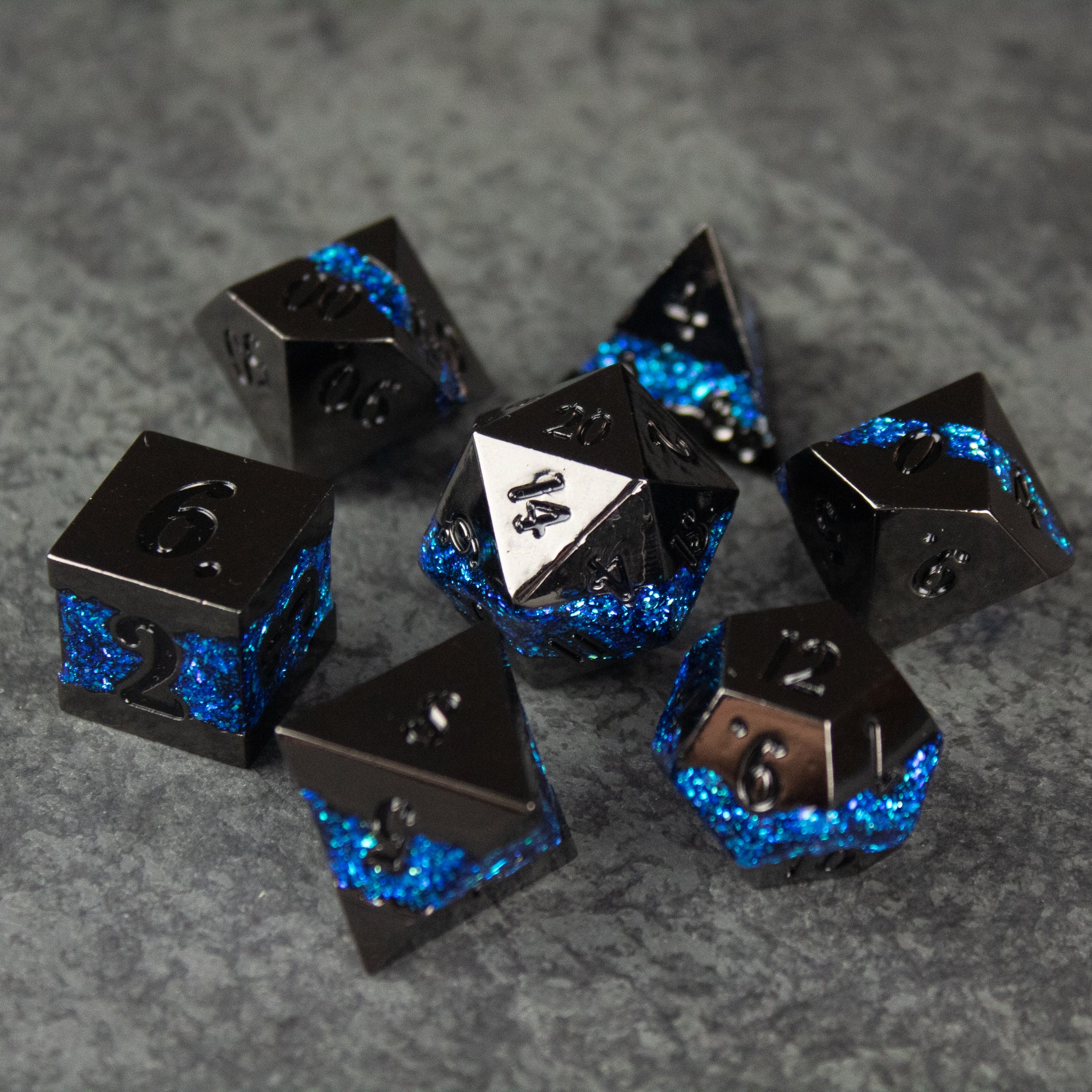 Blue Rift Dice Set - Black and blue metal polyhedral dice set with white 20-sided die for tabletop games.