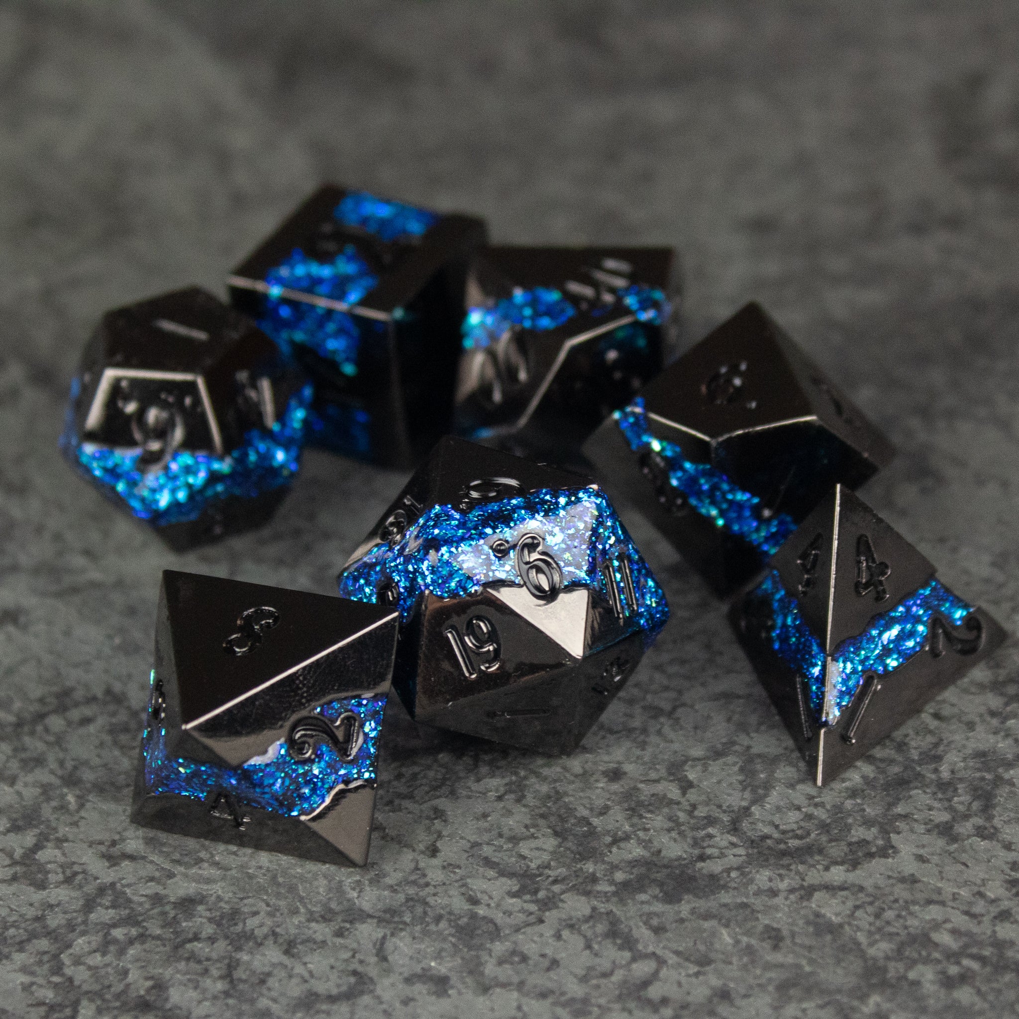 Blue Rift Dice Set - Set of black and metallic blue marbled polyhedral dice with silver numbers, designed for tabletop RPGs.
