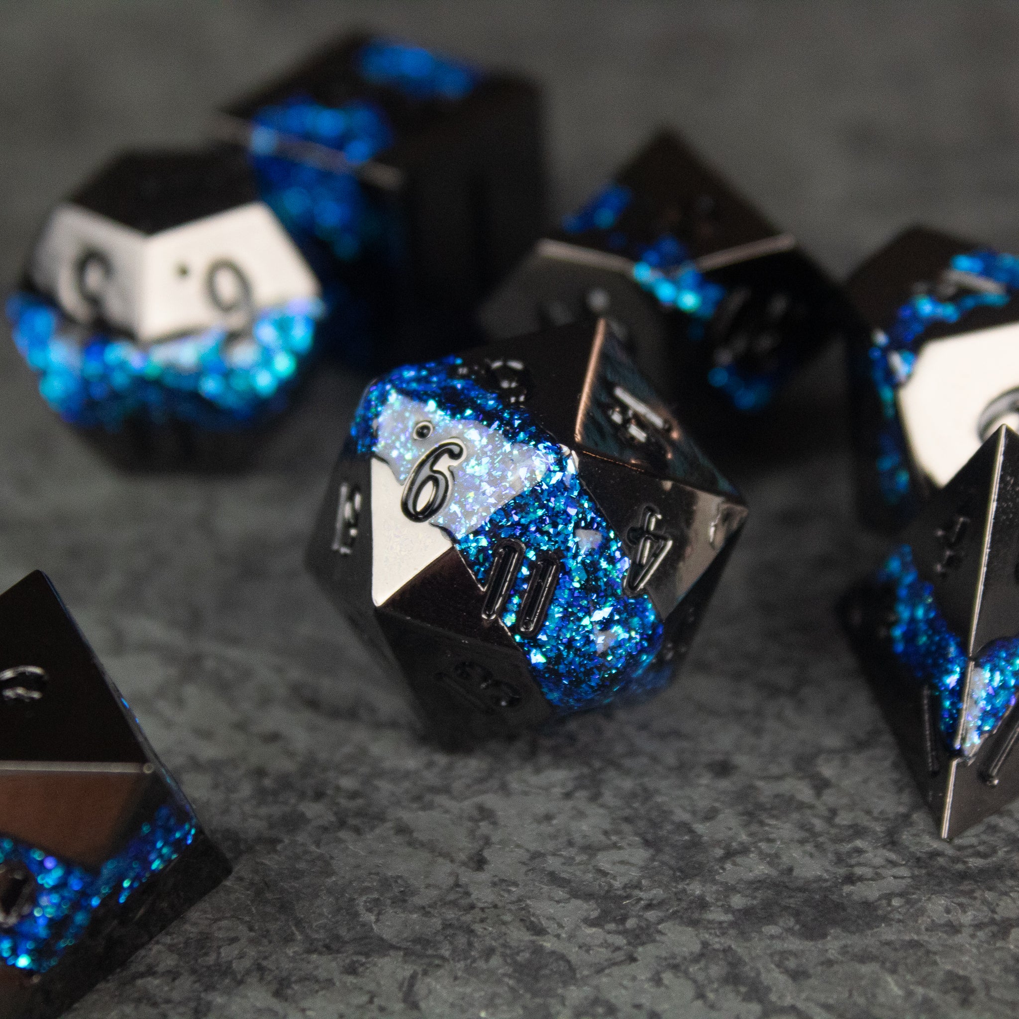 Blue Rift Dice Set - Black and blue metal polyhedral dice set with shimmering blue resin accents and silver numbering.