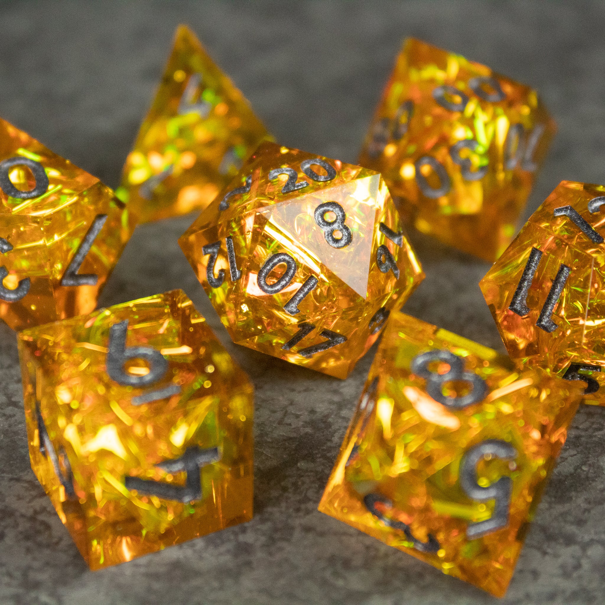Golden Order Dice Set - Gold translucent polyhedral dice set with sharp edges and silver numbers.