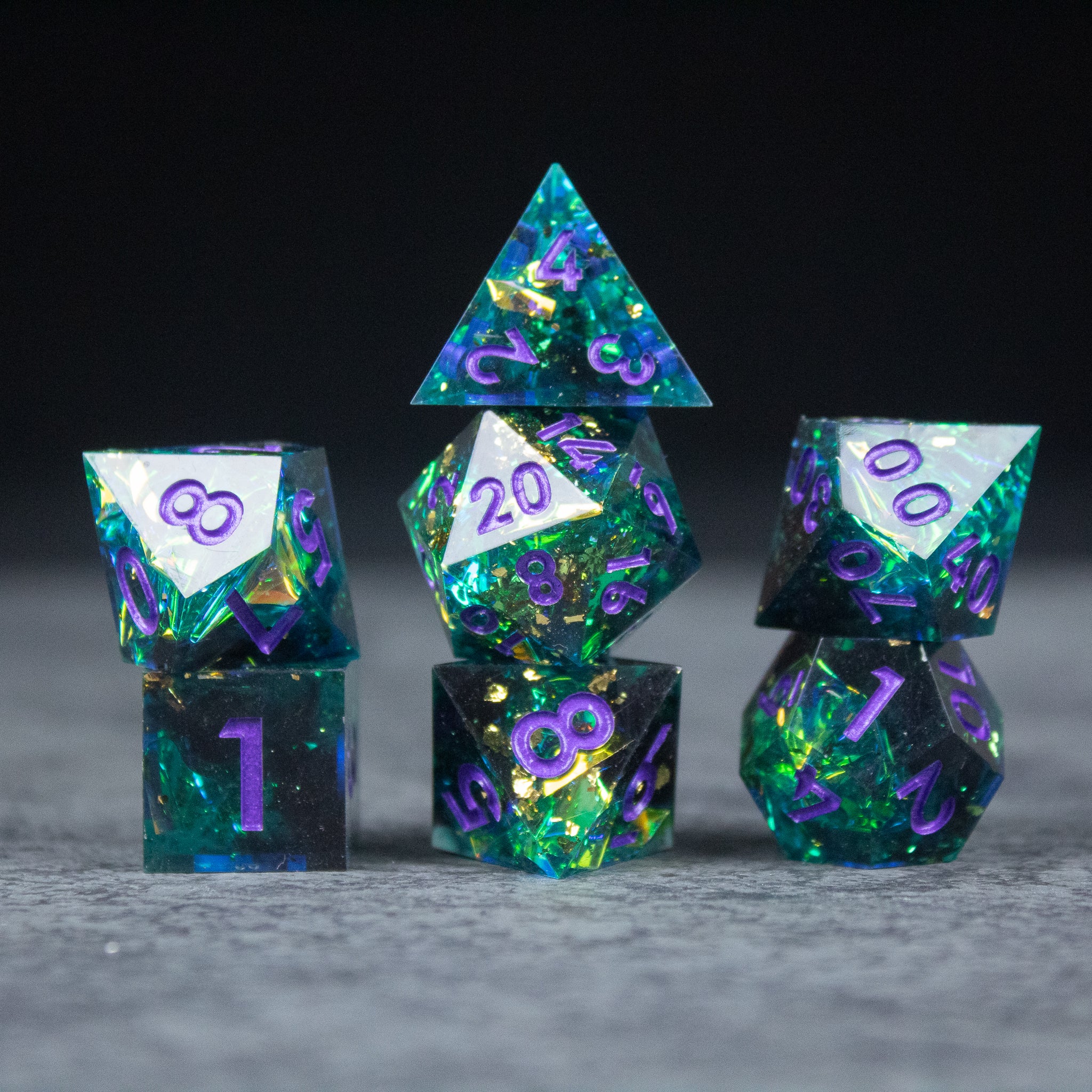 Deathblight Dice Set - Blue and purple sharp-edged necromancer dice set with glowing green flecks, including d20, d12, d10, d8, d6, and d4.