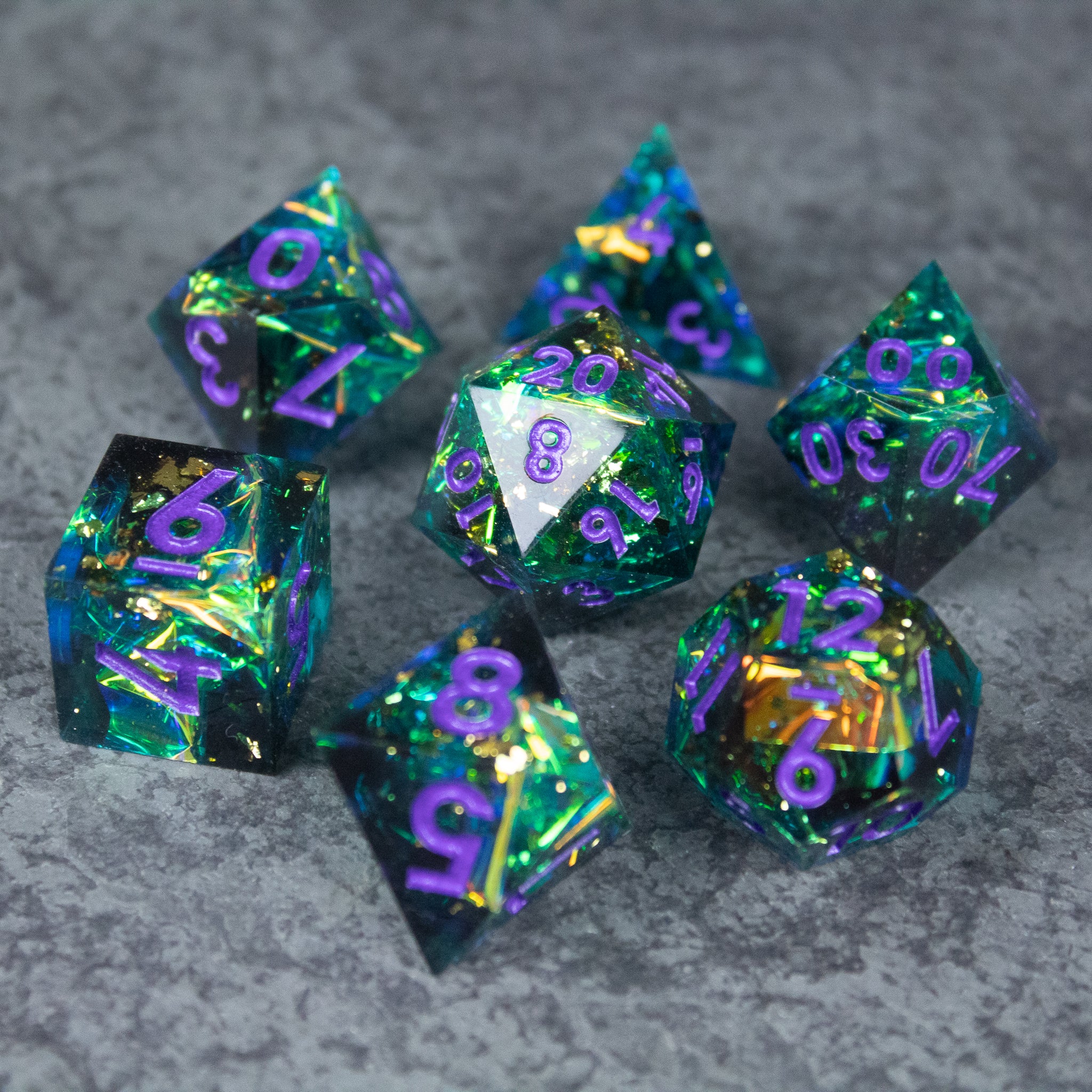 Deathblight Dice Set - Blue and green sharp-edged necromancer-themed dice set with purple numbers and gold flakes.