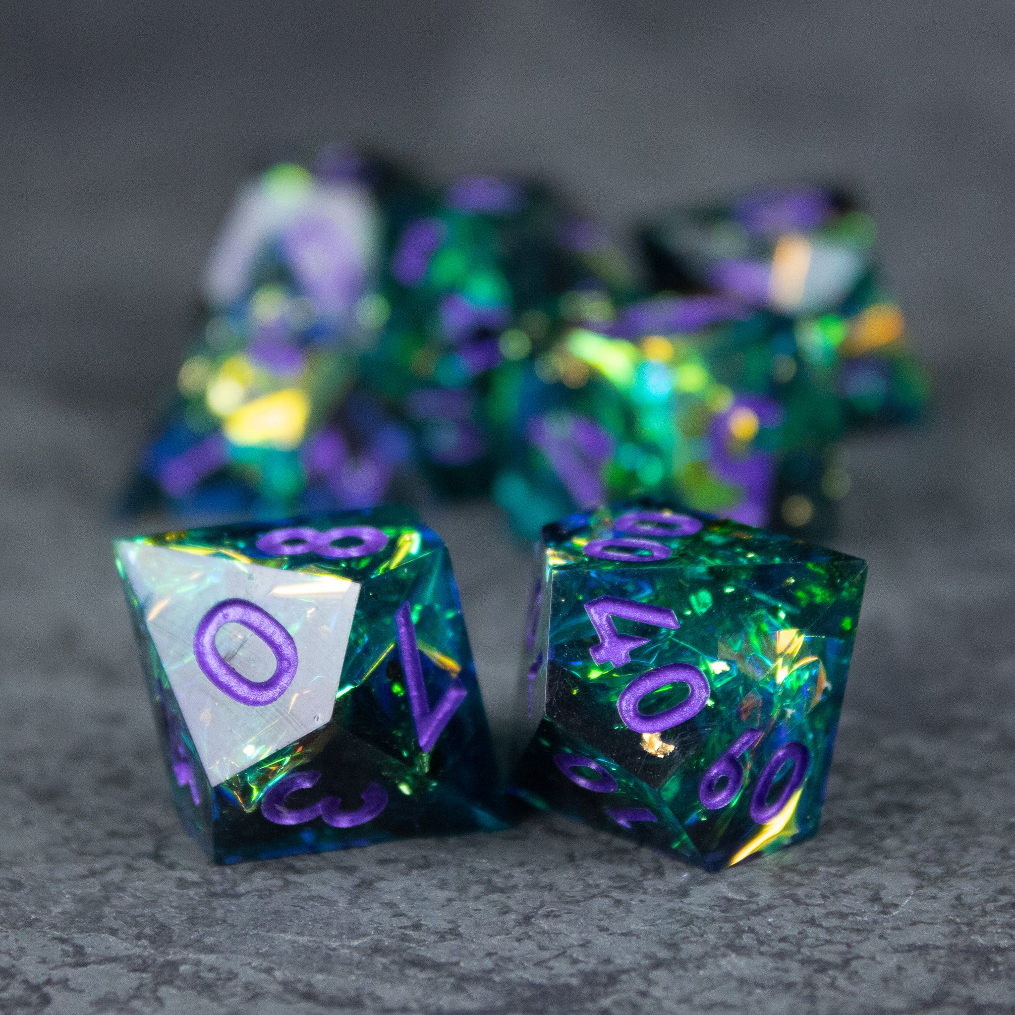 Deathblight Dice Set - Set of translucent blue-green sharp-edged polyhedral dice with purple numbers and shimmering internal flakes.
