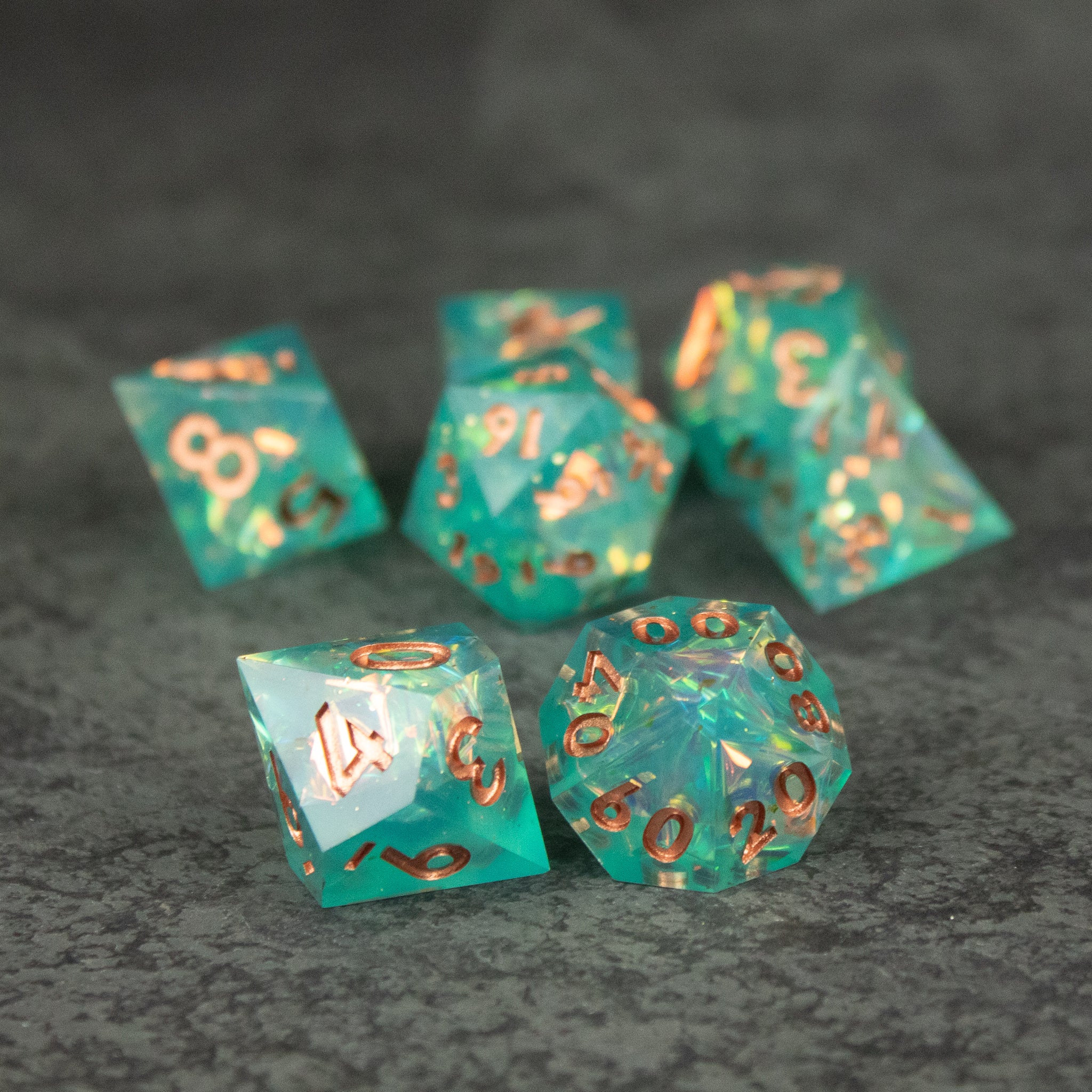 Residuum Dice Set - Set of six aquamarine green sharp-edged polyhedral dice with metallic copper numbers, including d20, d12, d10, d8, d6, and.