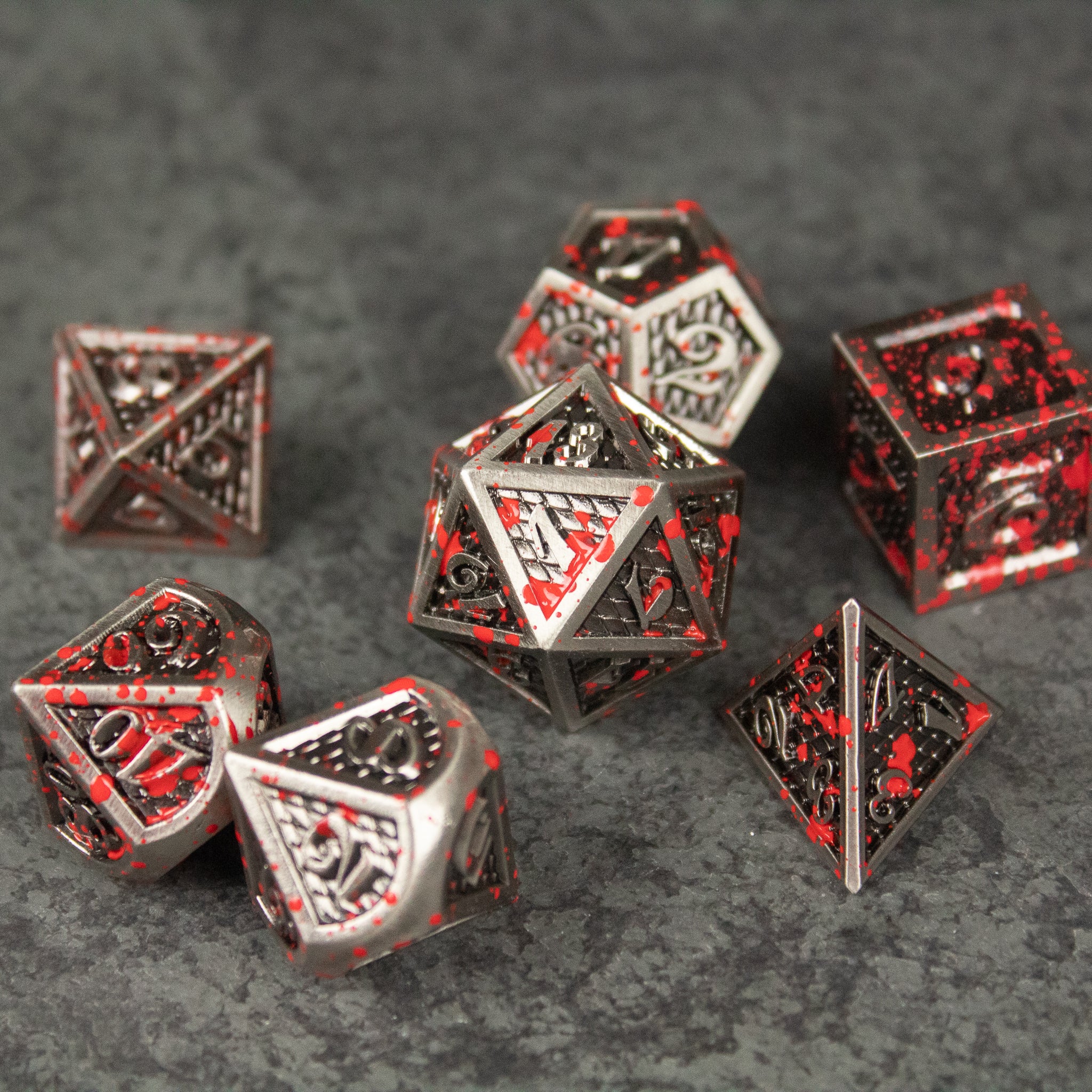 Marauder Dice Set - Metallic silver polyhedral dice set with red accents and intricate barbarian-themed engravings.