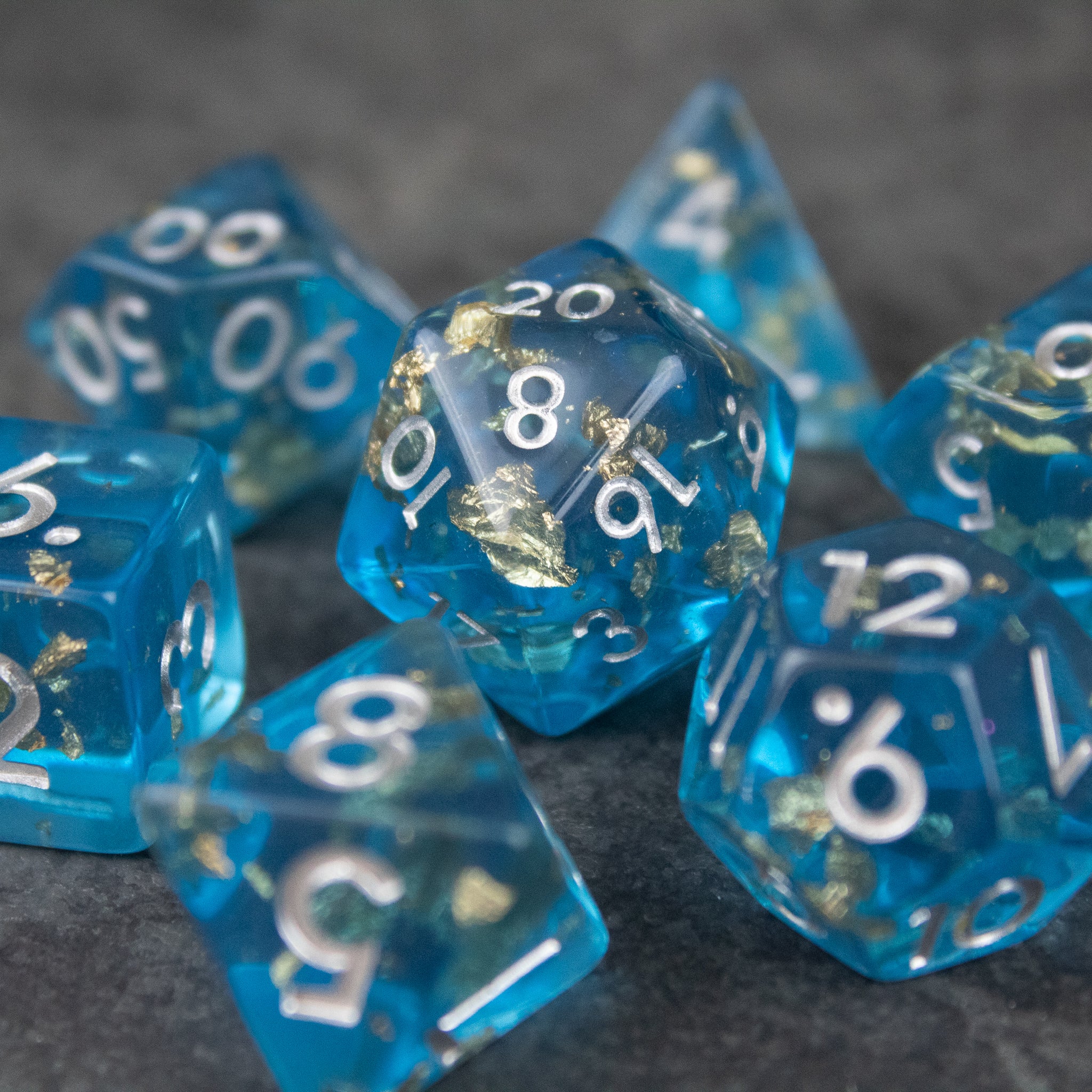 Blue Foil Dice Set - Blue translucent foil dice set with white numbering, including various polyhedral shapes for gaming.