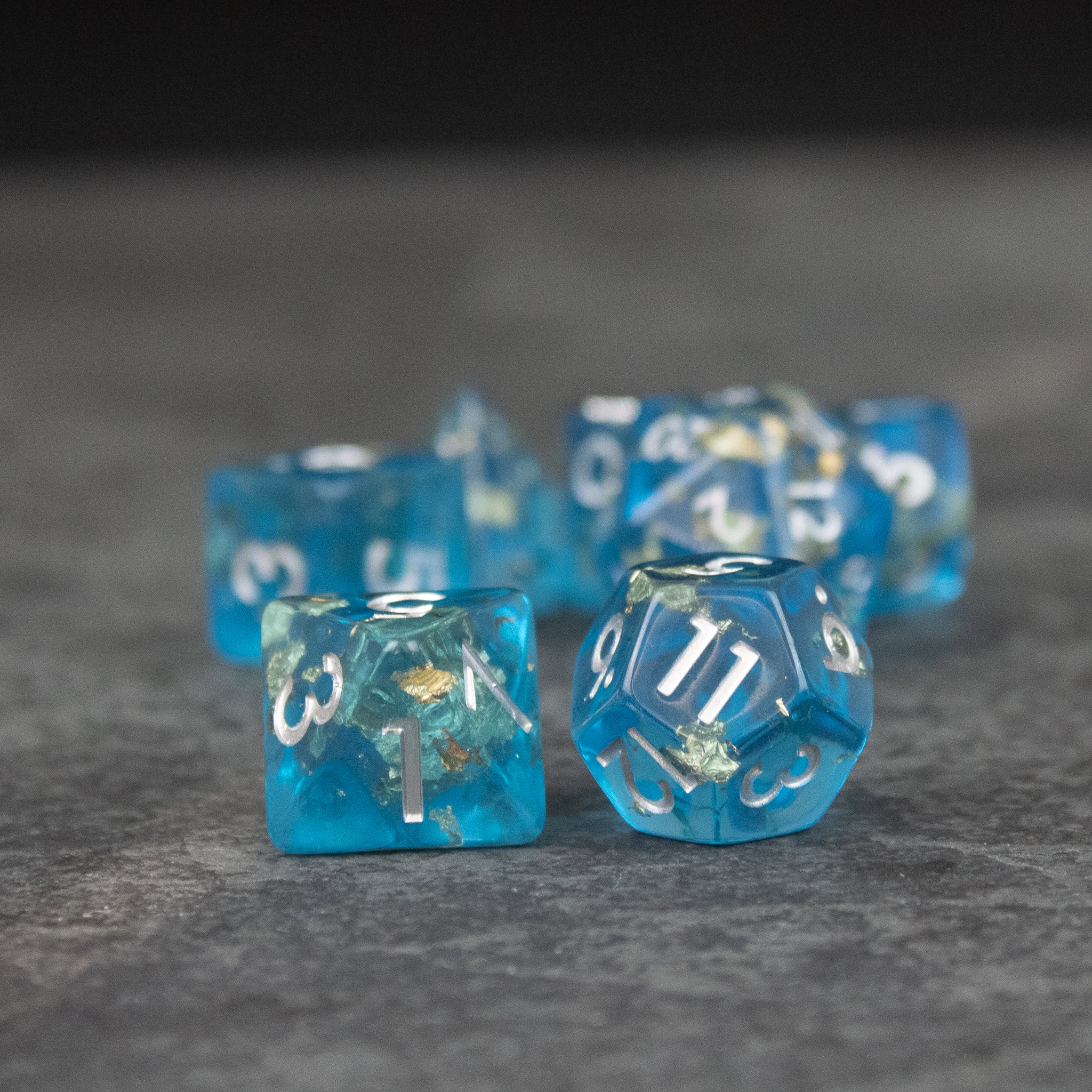 Blue Foil Dice Set - Set of translucent blue polyhedral dice with white numbering and foil accents inside.
