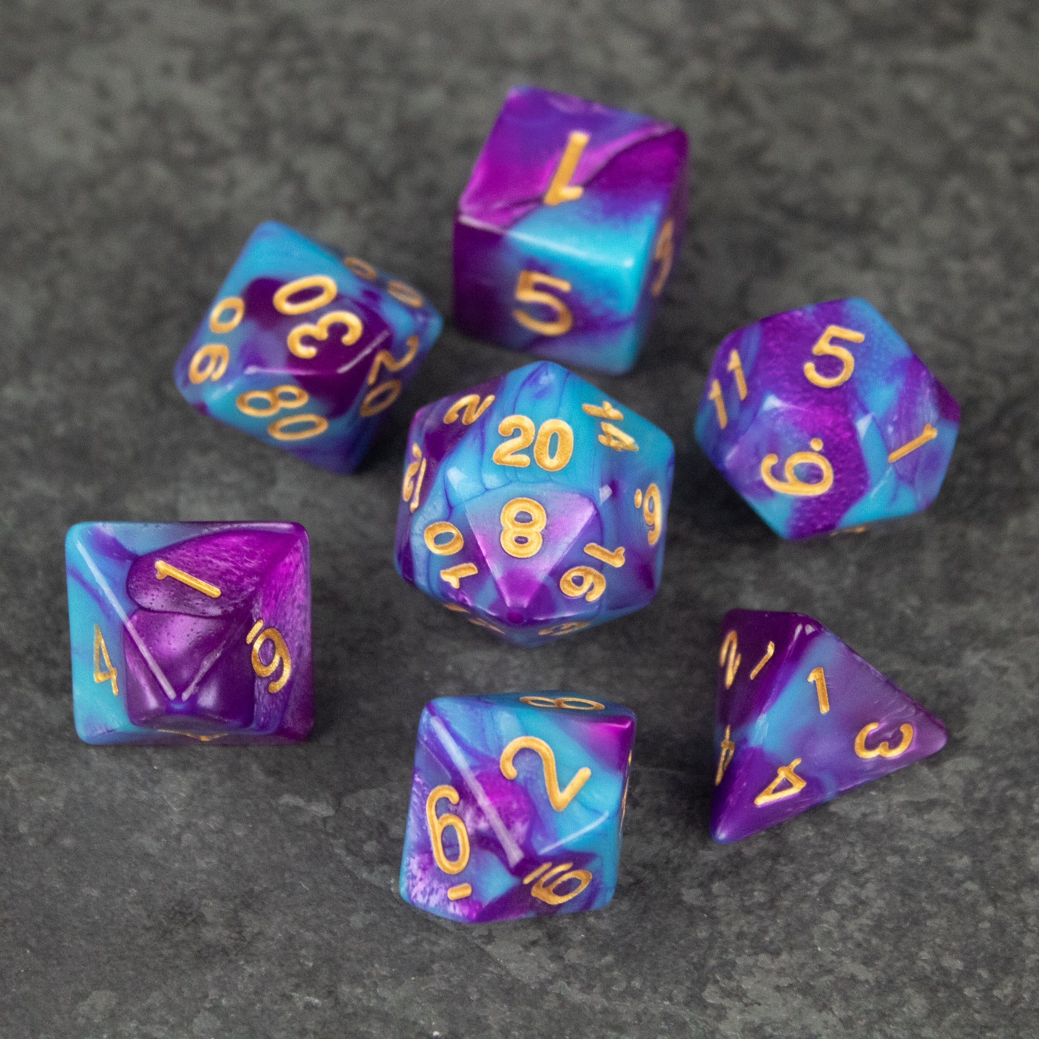 Purple and Blue Marbled Dice Set - Set of seven acrylic dice with vibrant purple and blue marbled patterns and gold numbering.
