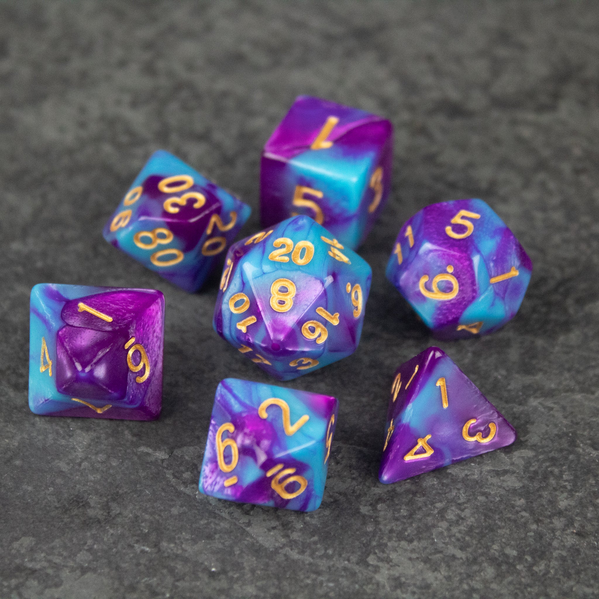 Purple and Blue Marbled Dice Set - Seven purple and blue marbled acrylic dice with gold numbers, including d20, d12, d10, d8, d6, and d4 shapes.