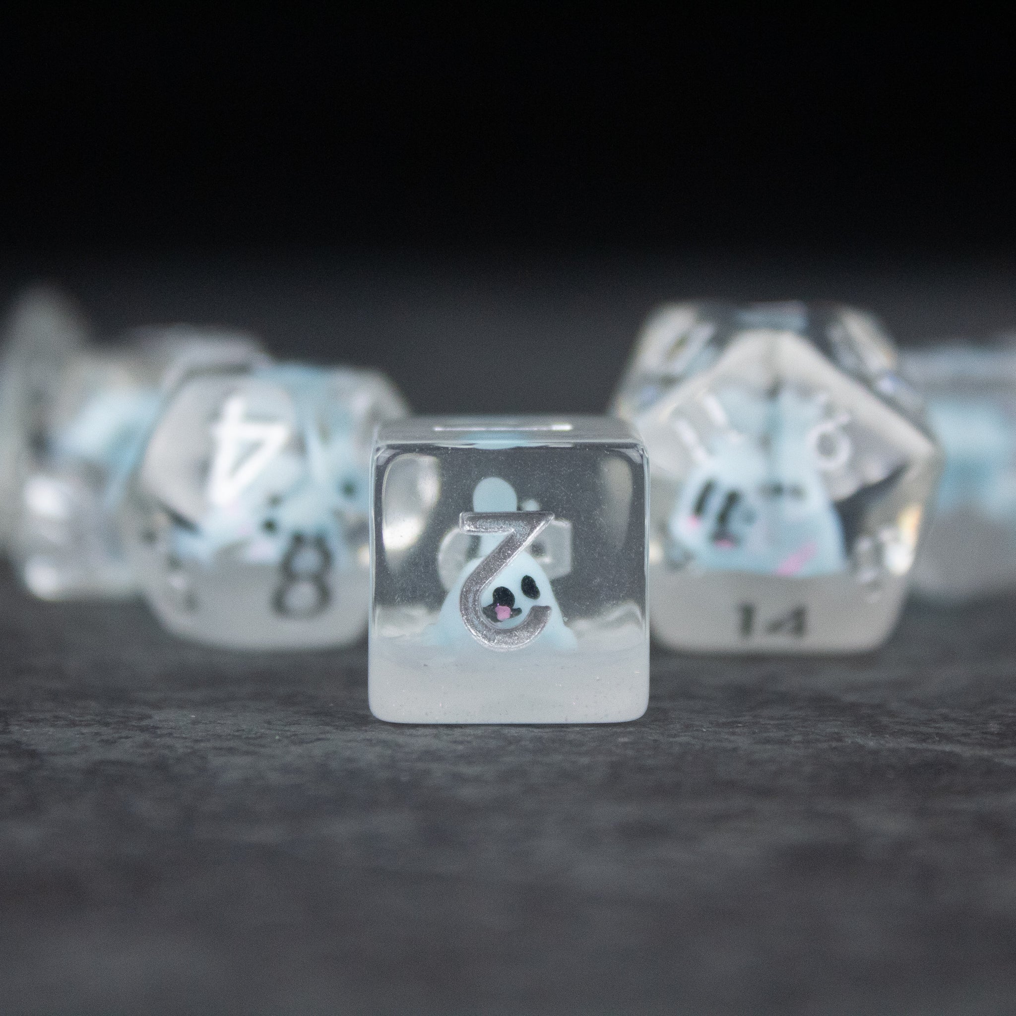 Blue Seal Dice Set - Clear blue six-sided die with a white seal icon, surrounded by translucent polyhedral dice with white numbers.