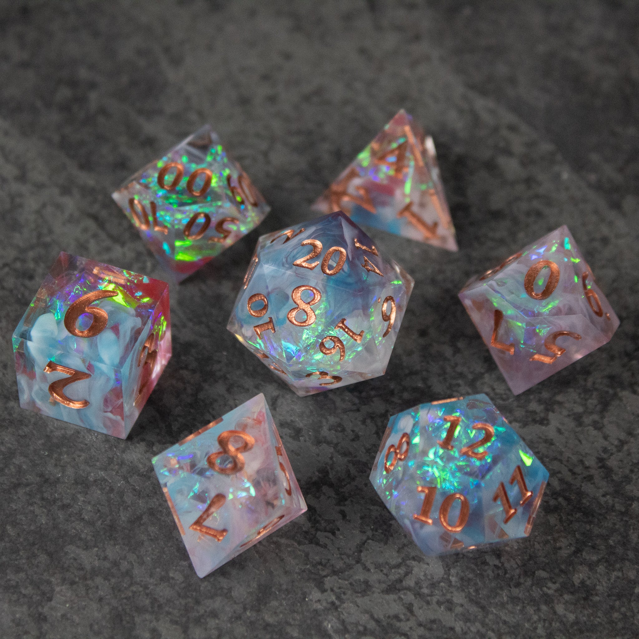 Divination Dice Set - Set of seven iridescent sharp-edged polyhedral dice with gold numbering.