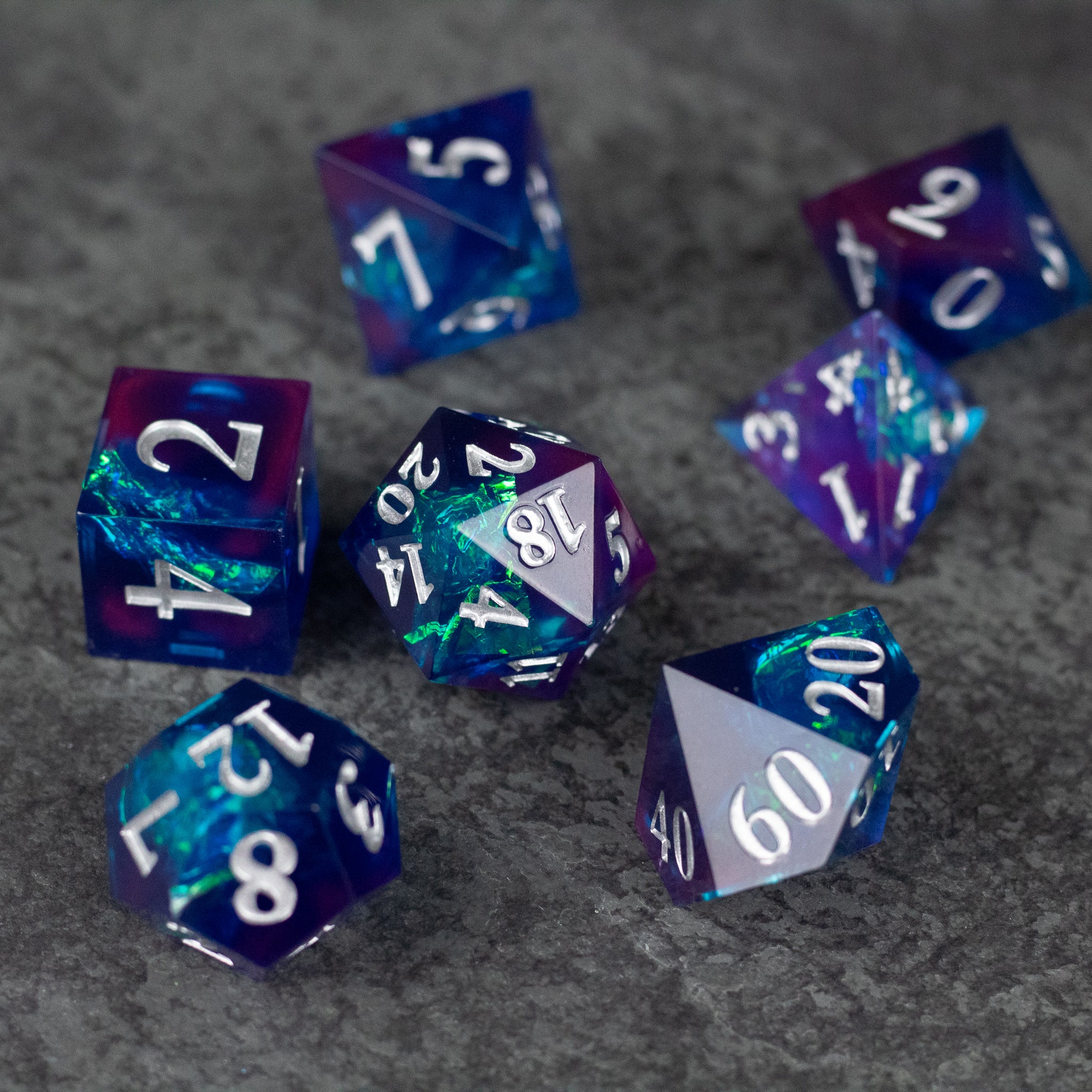 Midnight Blue Dice Set - Midnight blue sharp-edged dice set with white numbering, featuring translucent and opaque swirling colors.