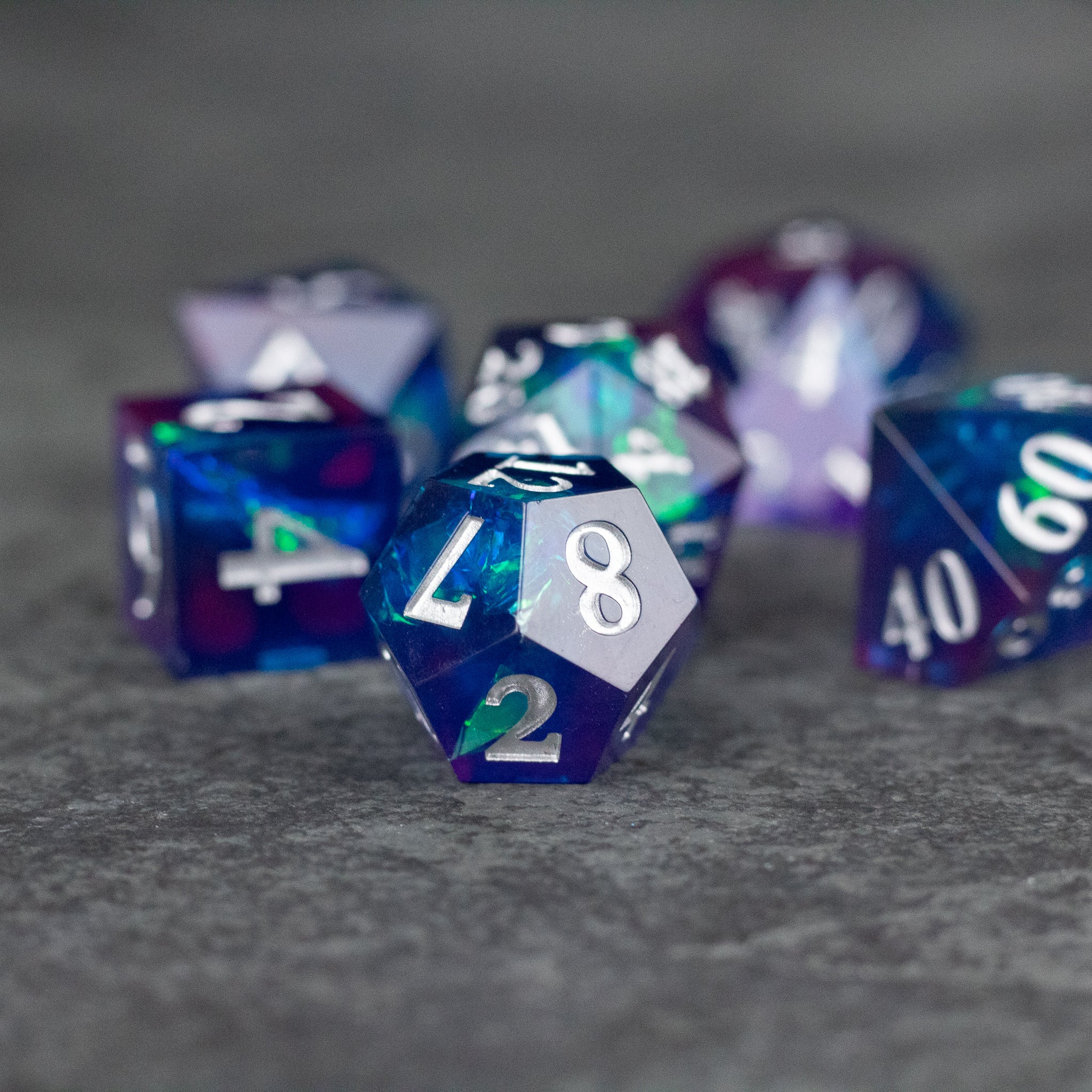 Midnight Blue Dice Set - Set of translucent midnight blue polyhedral dice with sharp edges and white numbers.