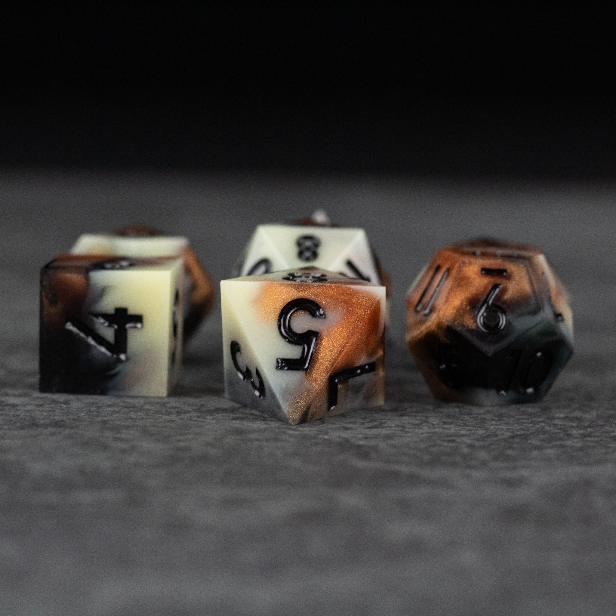Dwarven Delight Dice Set - Set of six sharp-edged dice in cream and burnt orange with black numbering, stone-like texture.