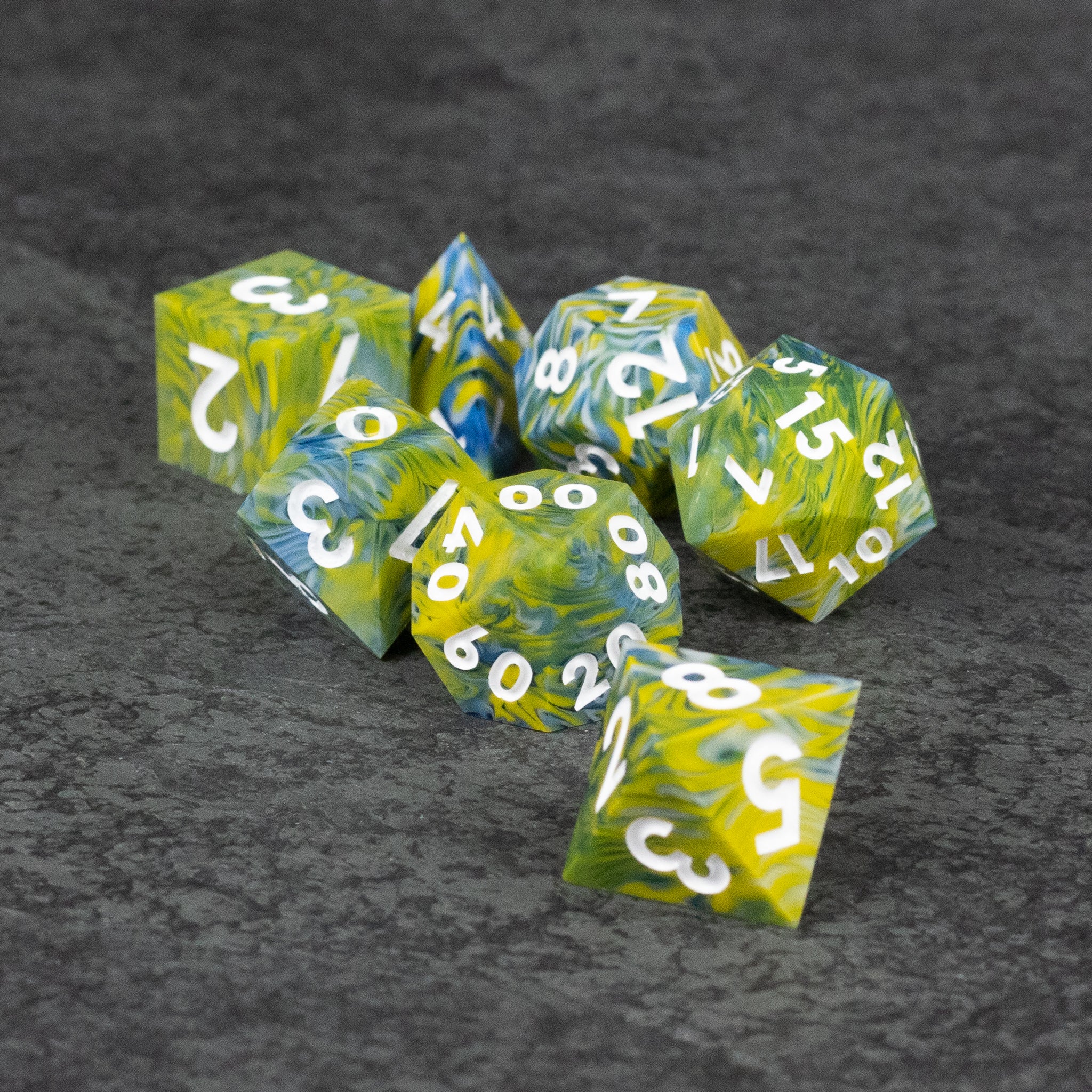 Acid Splash Dice Set - Set of green and yellow sharp-edged polyhedral dice with white numbers on a dark surface.