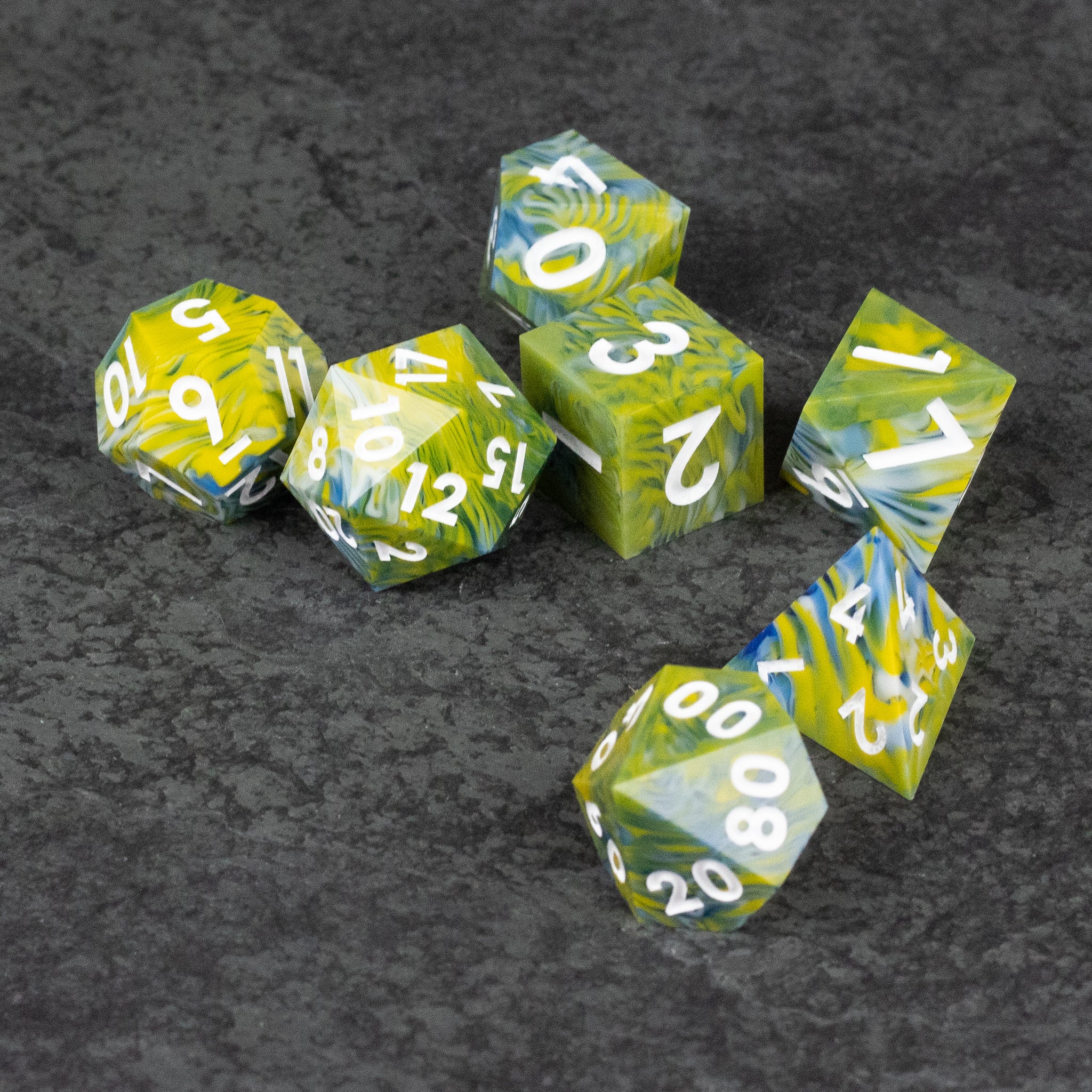 Acid Splash Dice Set - Set of six translucent green and yellow sharp-edged polyhedral dice with white numbers on a dark textured surface.