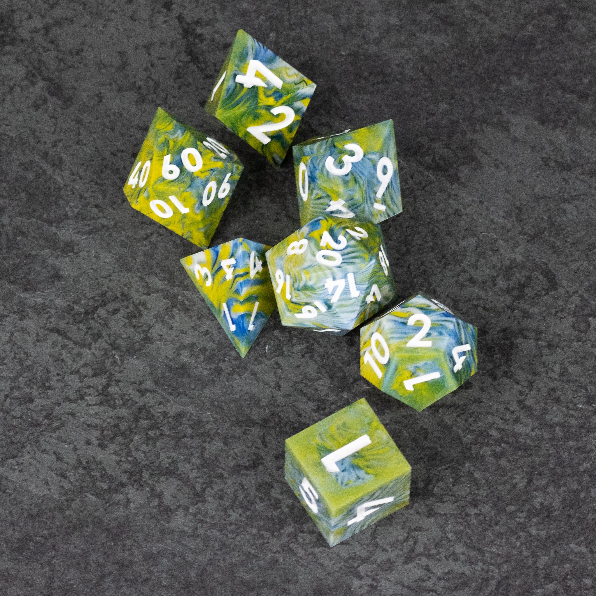 Acid Splash Dice Set - Green and yellow marbled seven-piece sharp-edged dice set with white numbering.