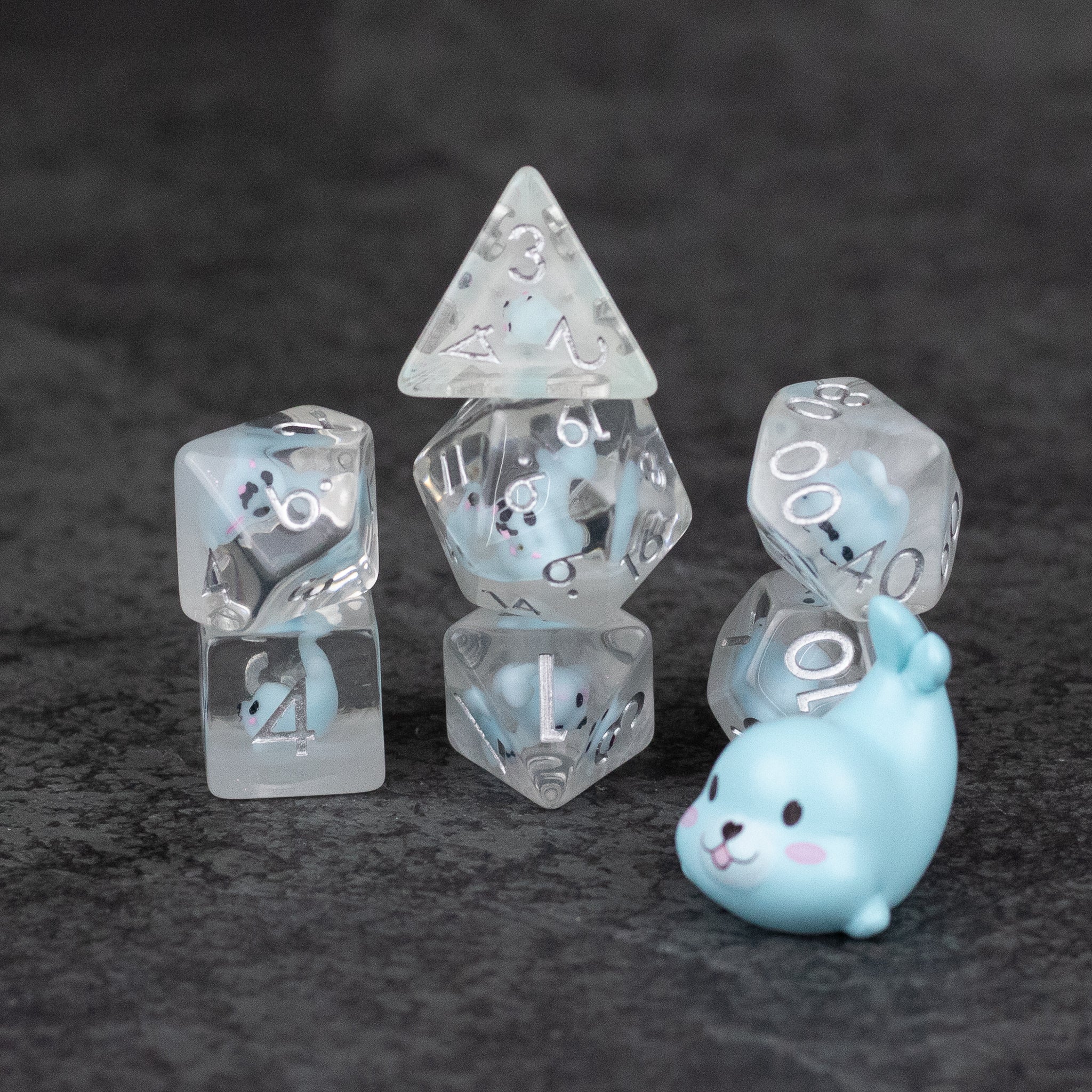 Blue Seal Dice Set - Translucent blue and white polyhedral dice set with seal illustrations and a small blue seal figurine.