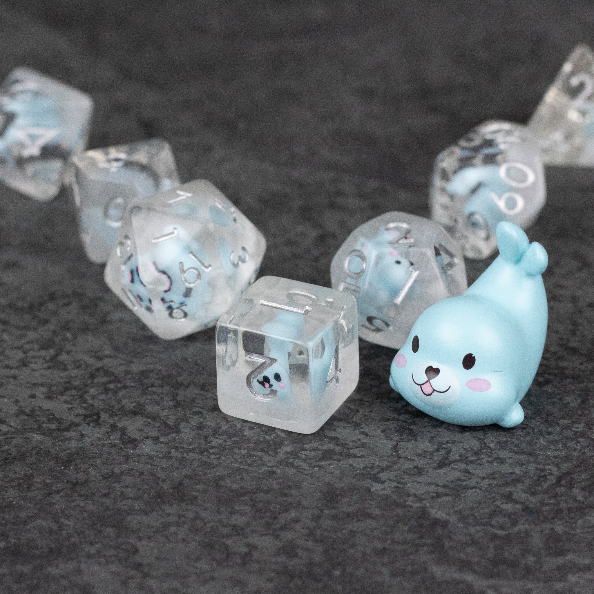 Blue Seal Dice Set - Transparent polyhedral dice with blue seals and black numbers, including a blue seal-shaped dice bag keychain.