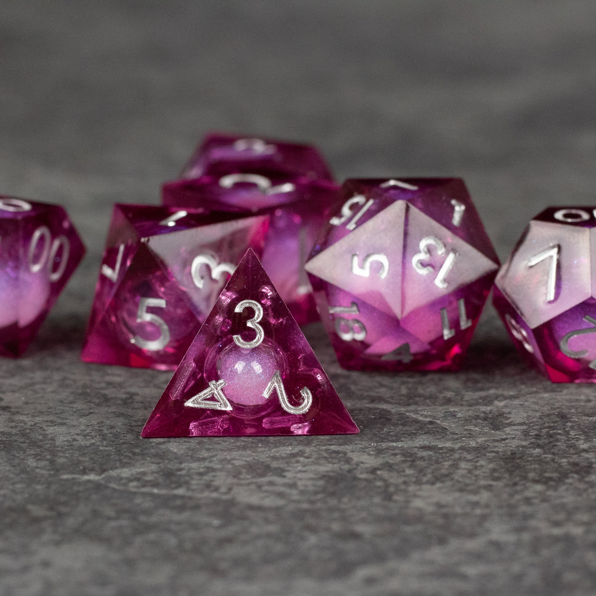 Magic Wine - Liquid Core Dice Set - Translucent deep red polyhedral dice set with sharp edges and white numbers, featuring liquid core design.