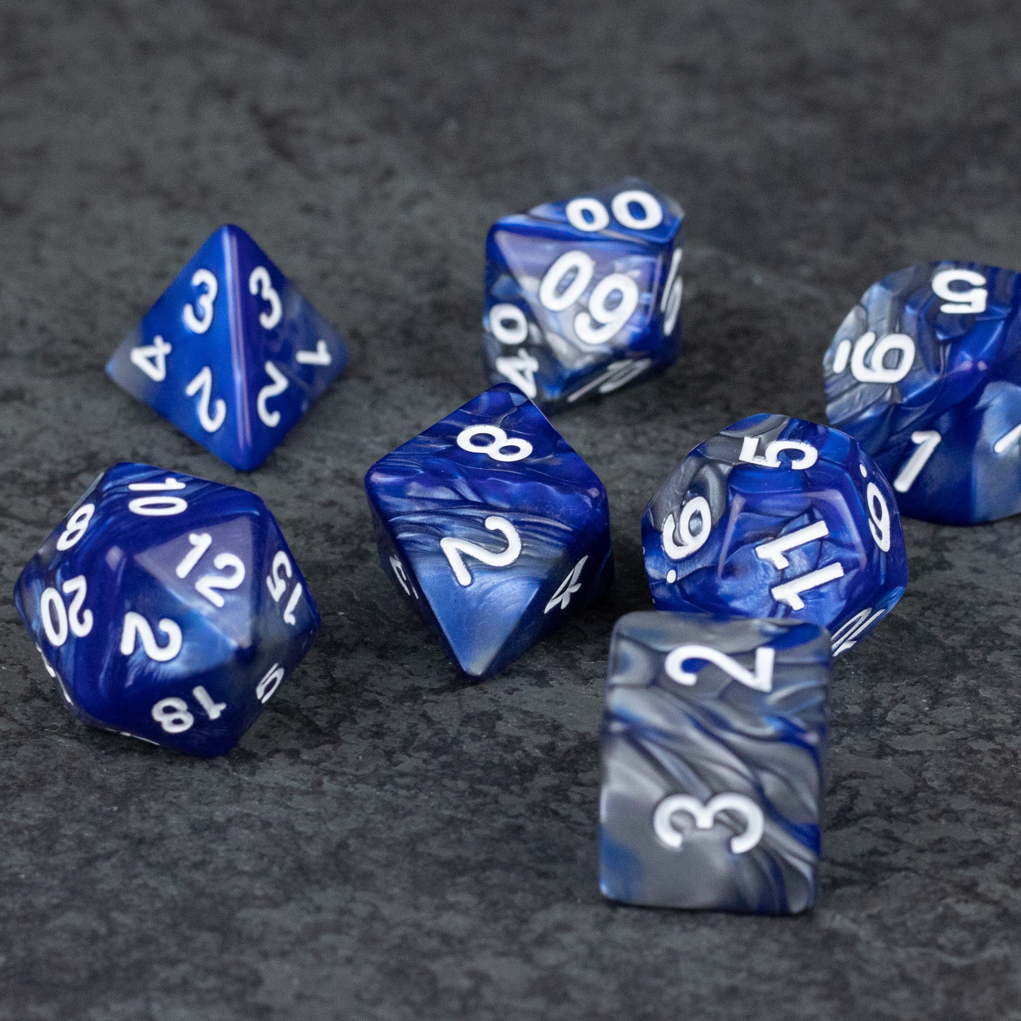 Royal Blue and Silver Acrylic Dice Set - Set of marbled royal blue and silver acrylic dice with white numbers, featuring various polyhedral shapes.