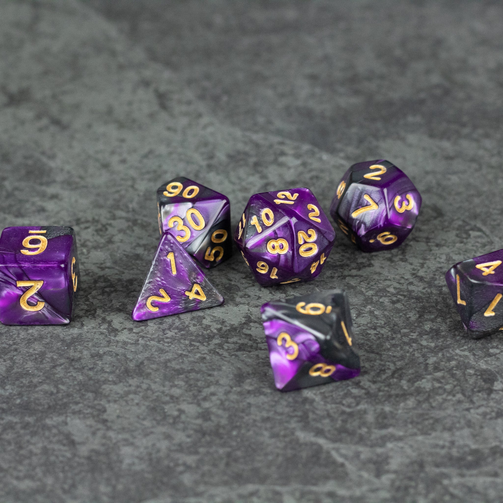 Purple and Black Marbled Dice Set - Purple and black marbled acrylic dice set with gold numbering, various polyhedral shapes.