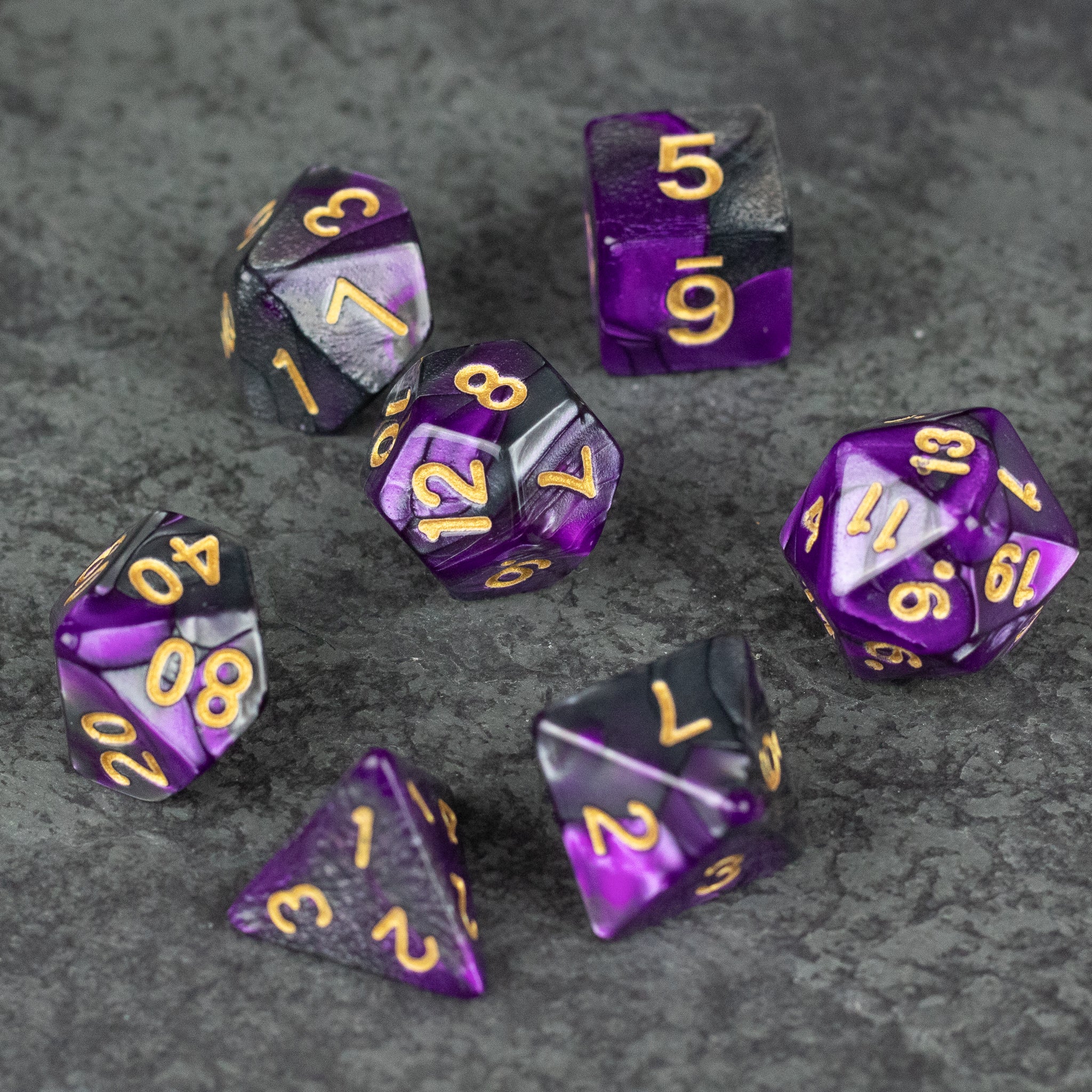 Purple and Black Marbled Dice Set - Set of seven acrylic dice with marbled purple and black patterns and gold numbers on each face.